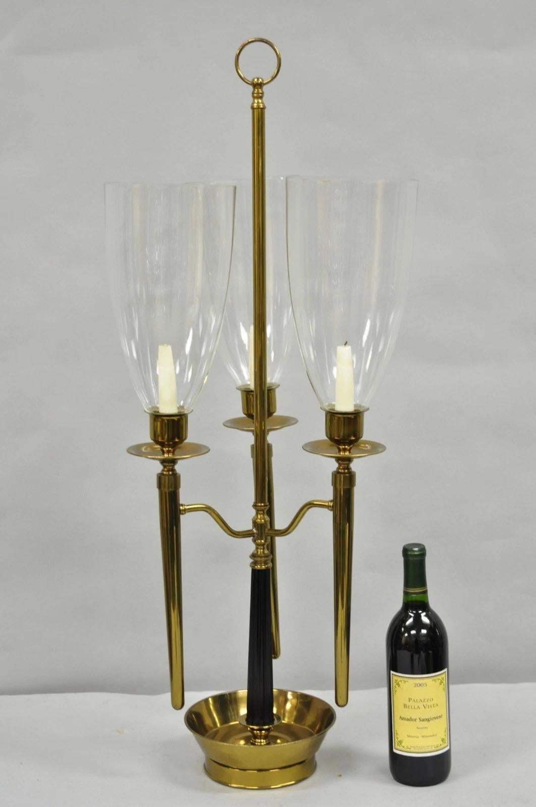Vintage Tommi Parzinger Style Mid Century Modern Tall Brass 3 Arm Hurricane Glass Shade Candelabra Candle Holder with Black Metal Reeded Column. Circa Mid 20th Century. Measurements: 35.5