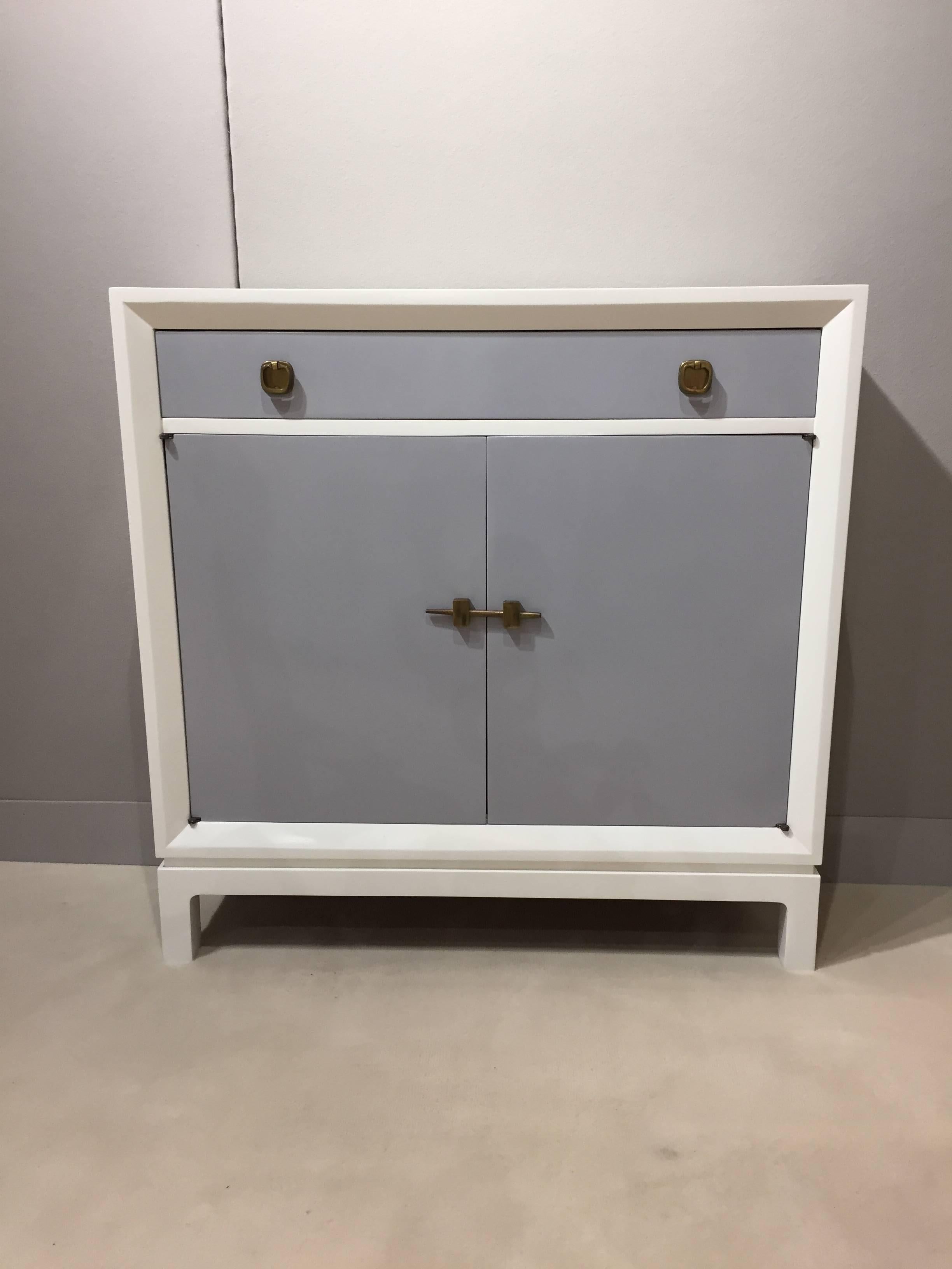 Tommi Parzinger style petite marble top grey and white lacquer bronze mount cabinet , with draw and two door storage compartment with shelf, wonderful entrance piece/ bathroom custom quality piece.