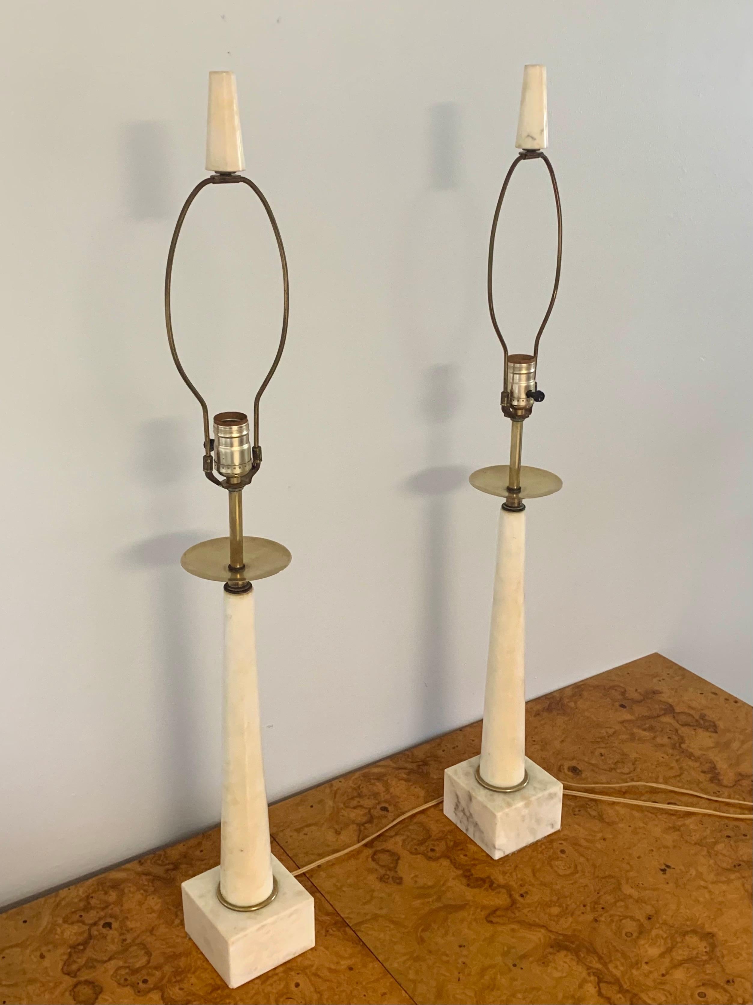 Stunning pair of Italian marble and brass table lamps. In the style of Tommi Parzinger for Stiffel. Gorgeous elegant form. Marble has great textures in it. Original harp and final. Would fit well in Mid-Century Modern, regency, natural or