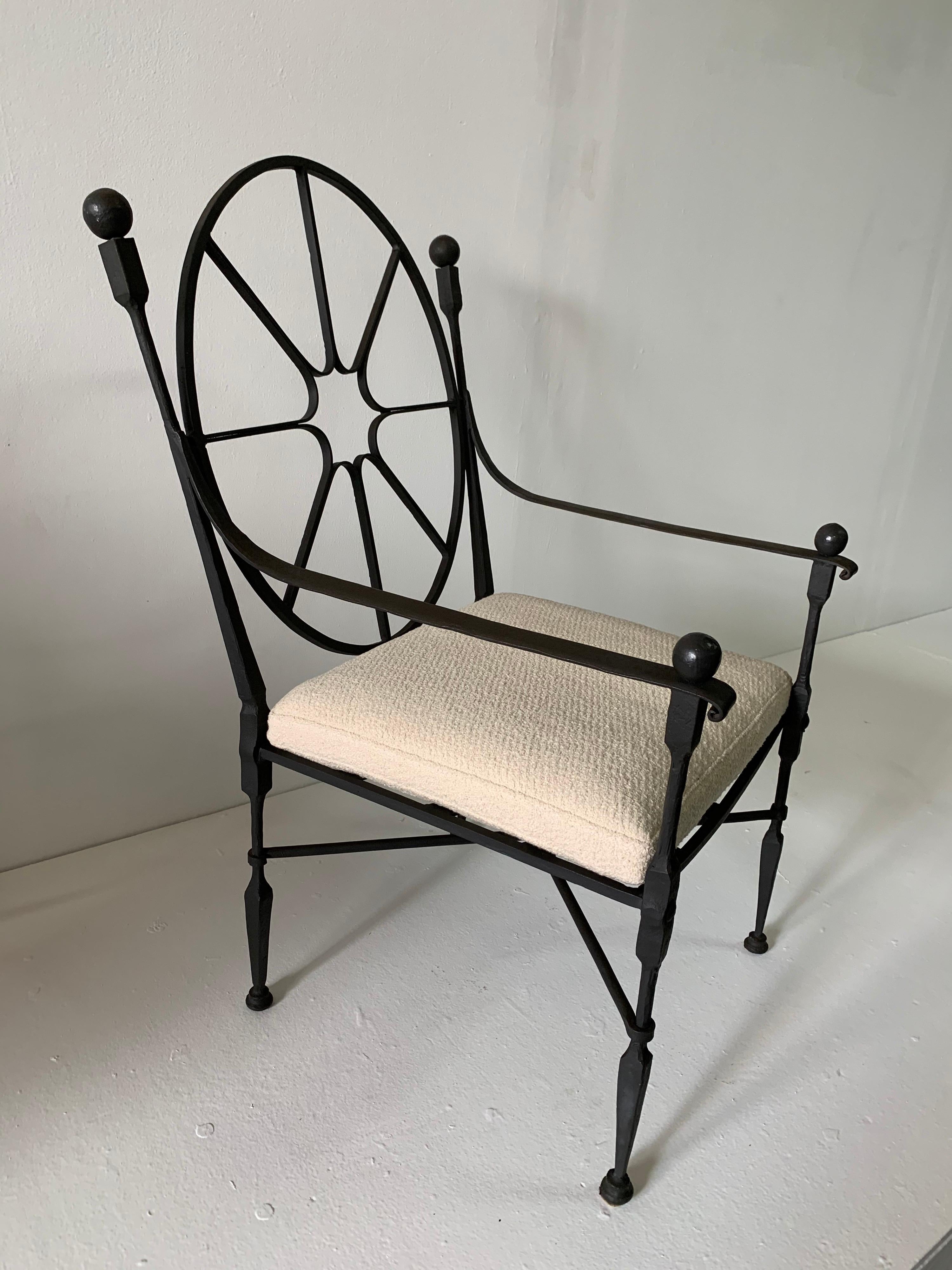 Exceptional craftsmanship in solid and heavy iron, boasts lovely details in the finials and sunburst backrest. Custom raw linen cushion.