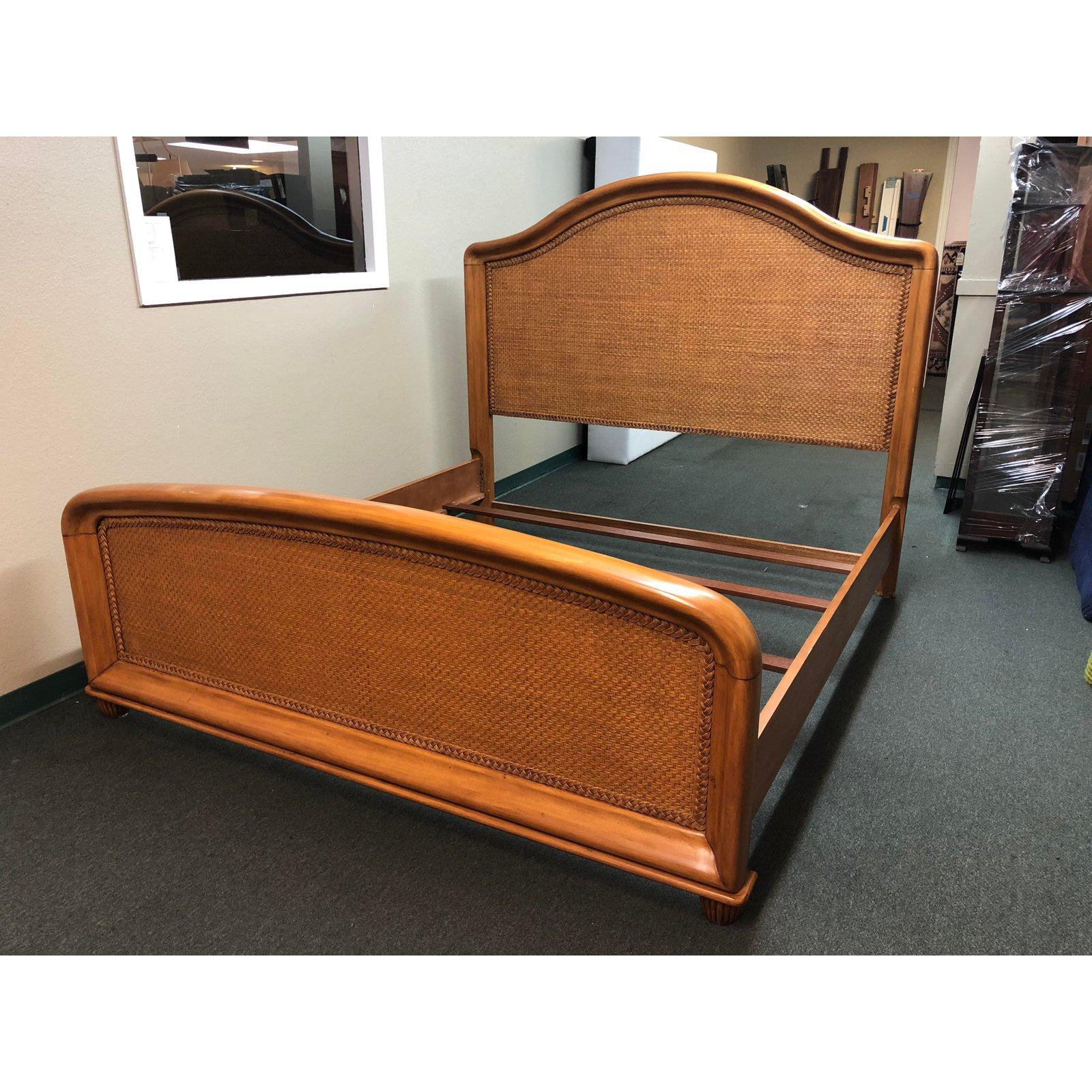 An Eastern king bed, by Tommy Bahama for Lexington Home. Lovely woven cane is surrounded by a solid curving frame inset with braided cane, for style and substance. Two of four slats have center support. Surface damage, scratch as shown.

Extra
