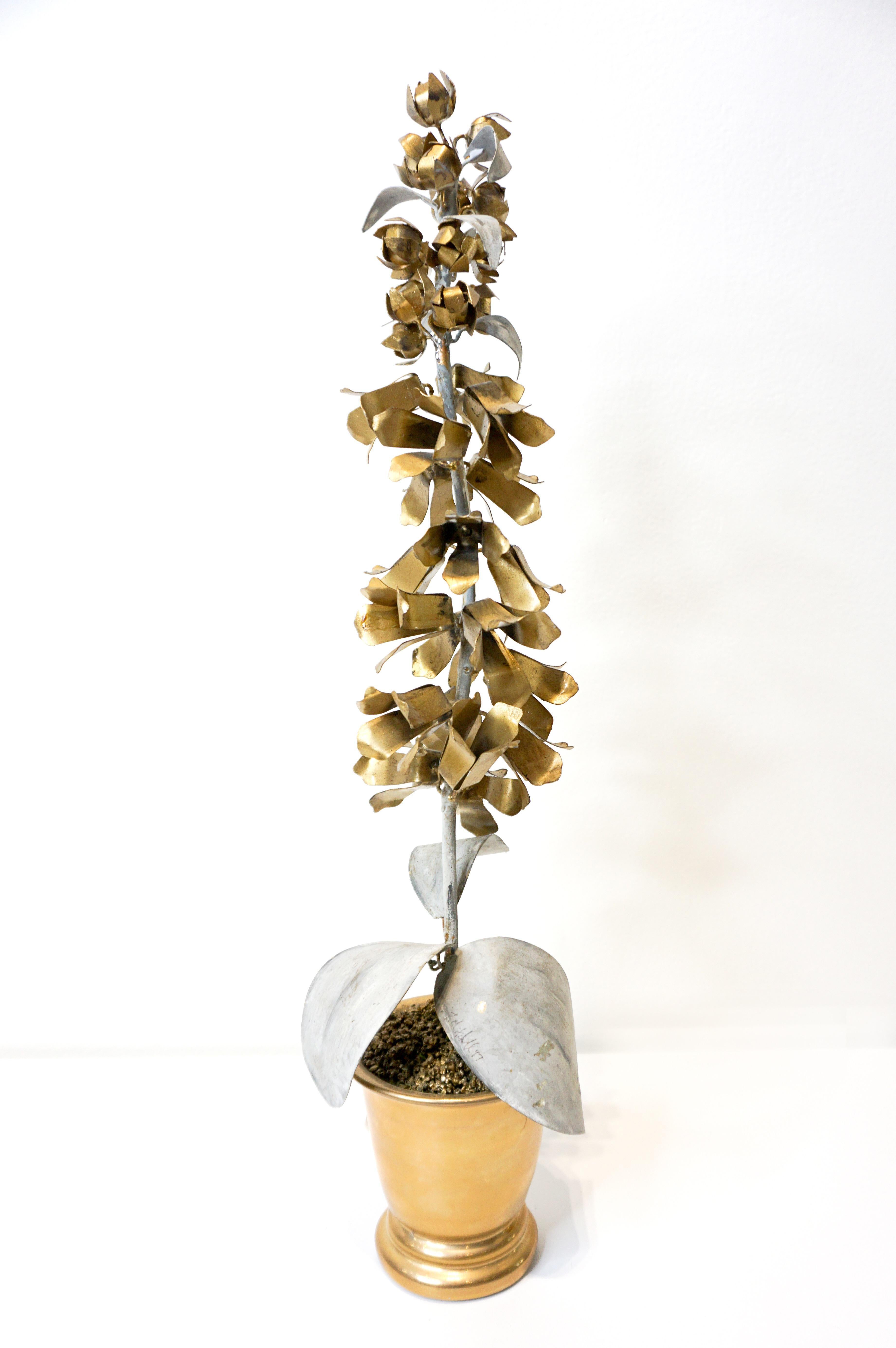 Hand painted Tommy Mitchell hollyhock tole flower in gold and zinc finish. Tommy Mitchell is a well-recognized artist in rendering florals in tole and hand painting them in his studios. This piece is sophisticated enough to be placed in the most