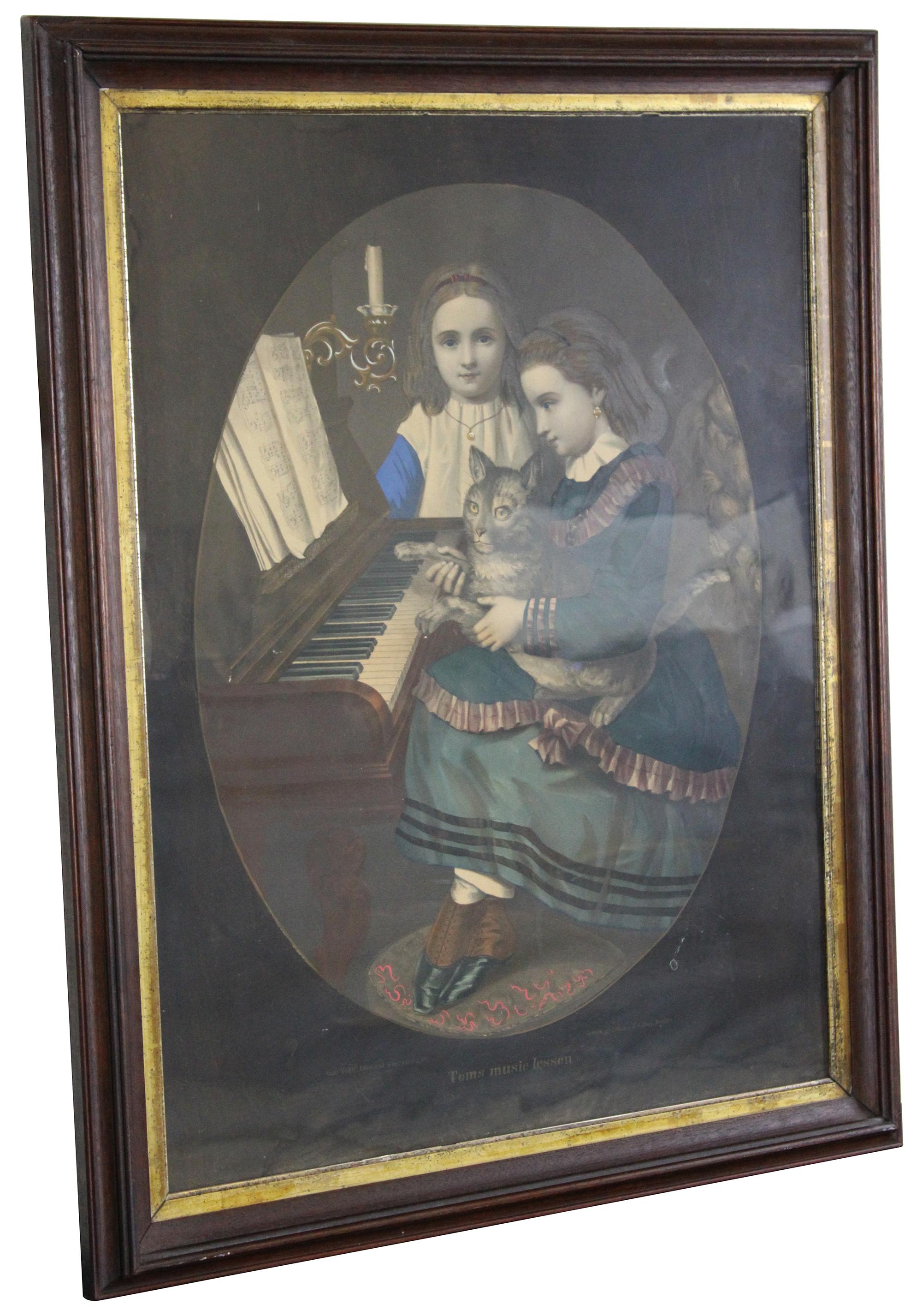 Antique Toms Music Lesson oval painted colored lithograph print by F. Silber for Edmund Foerster & Co. Features two Victorian clad girls / sisters at the piano with their cat. Framed in period antique gold gilt and mahogany frame with antique glass.