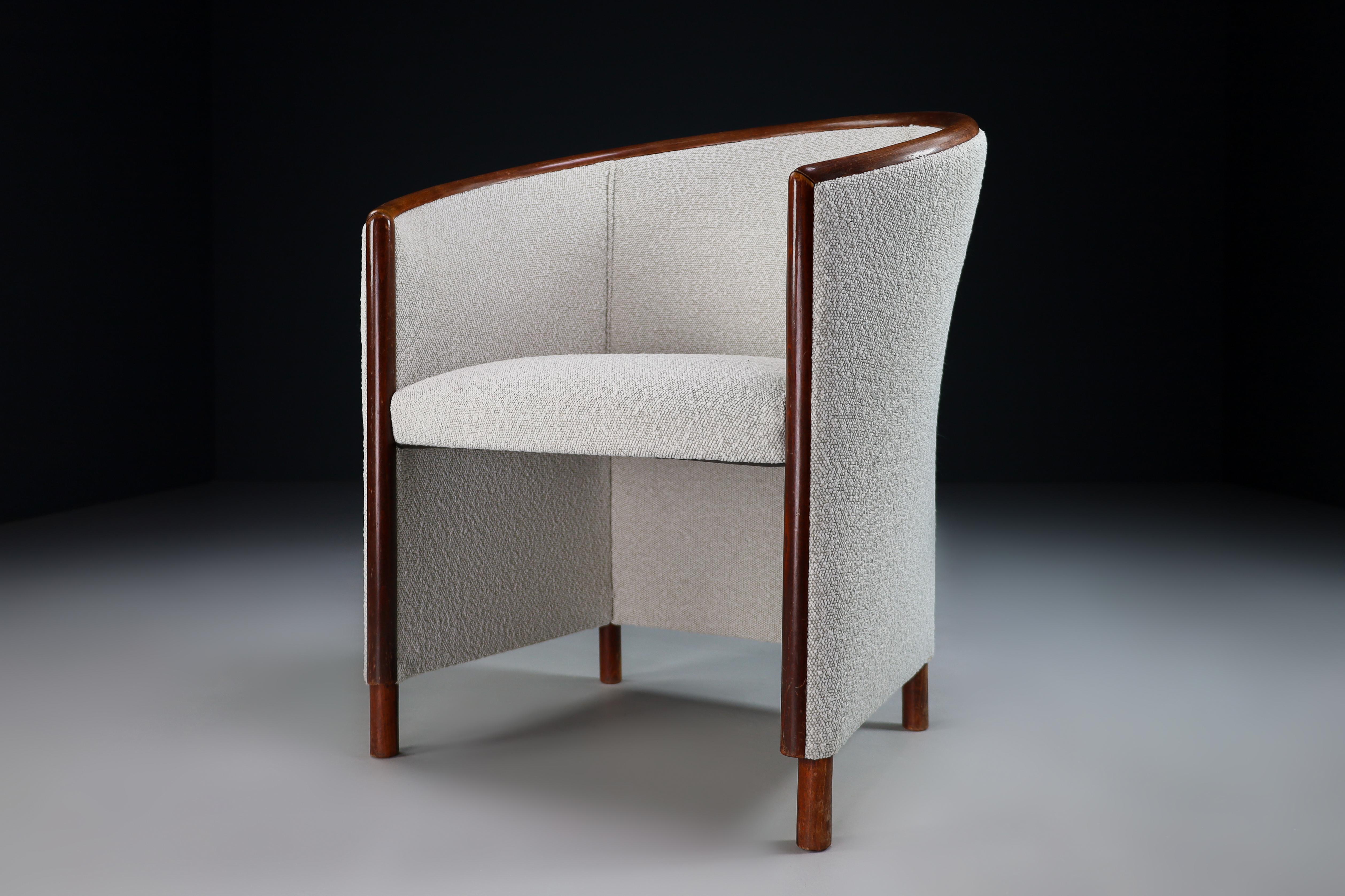 This elegant set arm chairs or club chairs, manufactured by Ton Czech Republic 1970s, features a wonderful bentwood frame. The round shape of the backrest surrounds the user. These chairs are just been reupholstered with Bouclé fabric. It is in