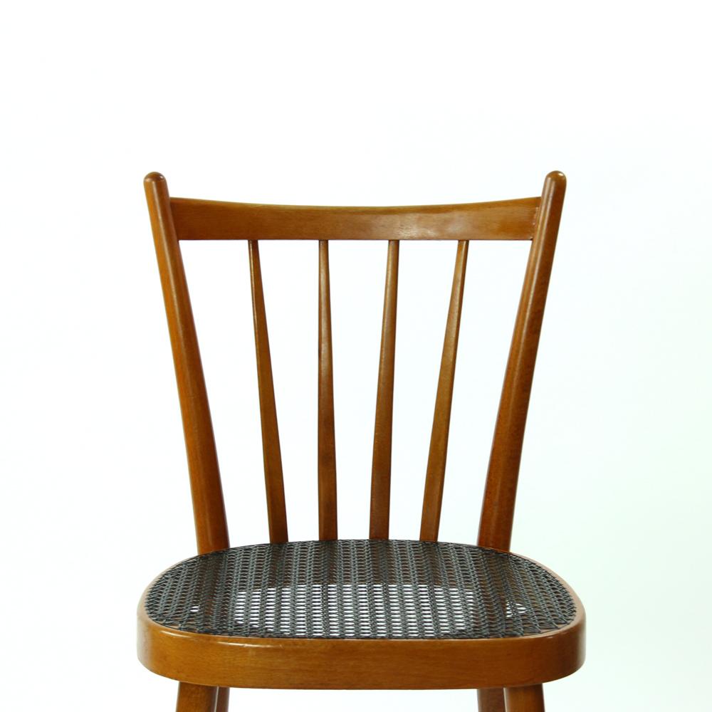 Set of 4 elegant dining chairs produced in 1970s by TON company. Made of wood with seat in black plastic wicker. The chairs and the seat are in very good condition. No damage on the seat wicker. Very elegant finish.