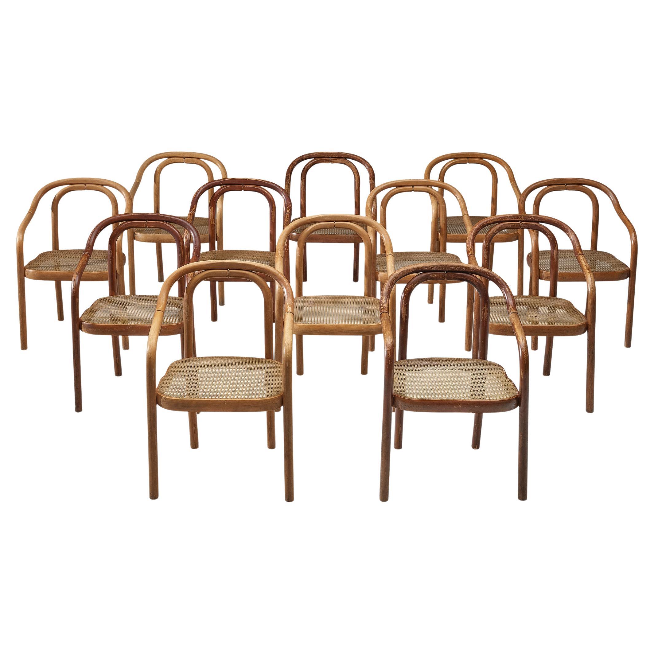 Ton, set of twelve dining chairs, bentwood, plastic webbing, Czech Republic, 1960s

This delightful set of armchairs is characterized by a bentwood frame featuring elegant round corners and clear lines. The engraved rings add a subtle detail to