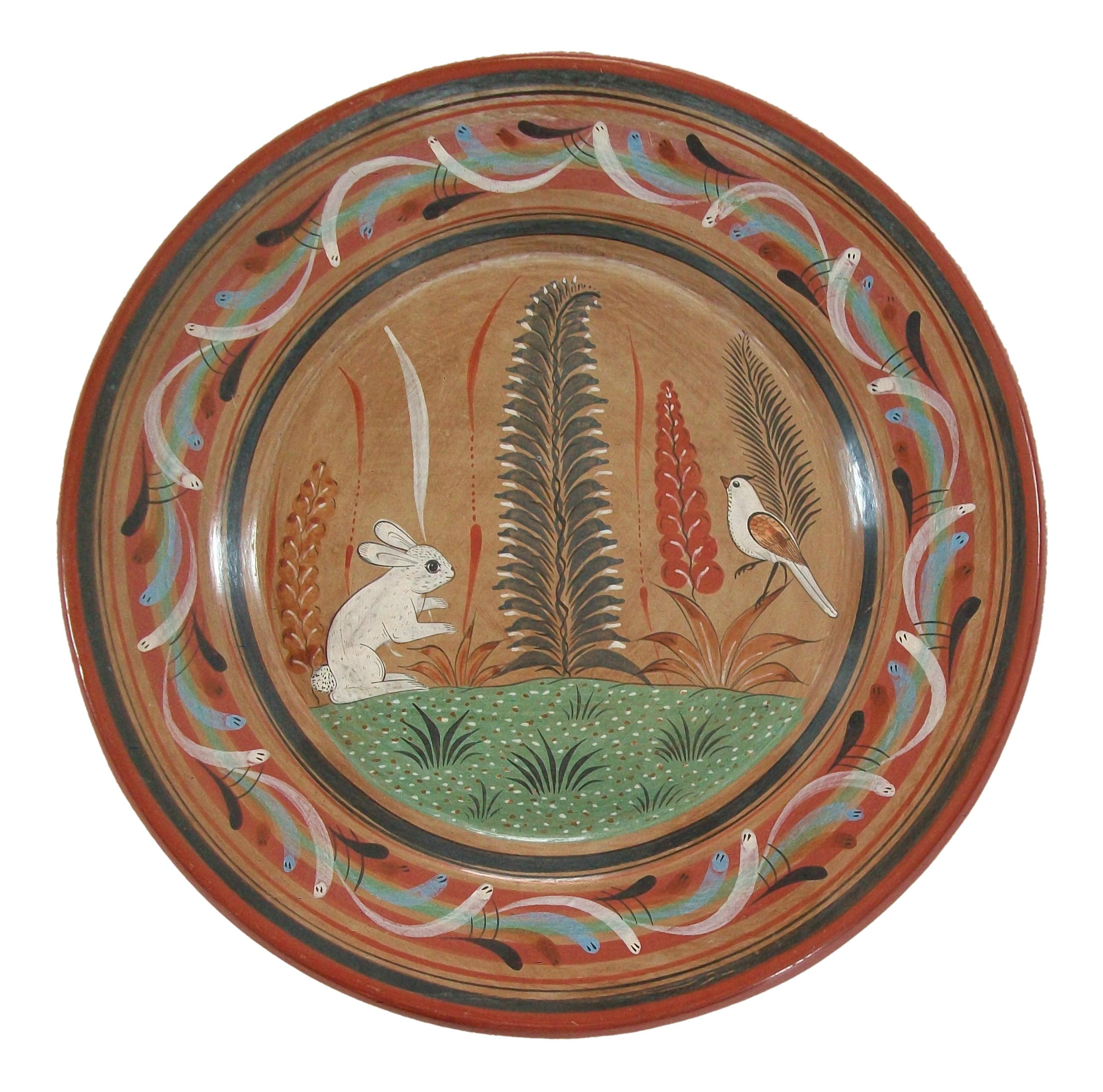 Tonala folk art pottery charger or wall plate - large size - hand made and hand painted with a rabbit, bird and foliage - elaborate border - unsigned - Mexico - circa 1970's. 

Excellent vintage condition - no loss - no damage - no restoration -