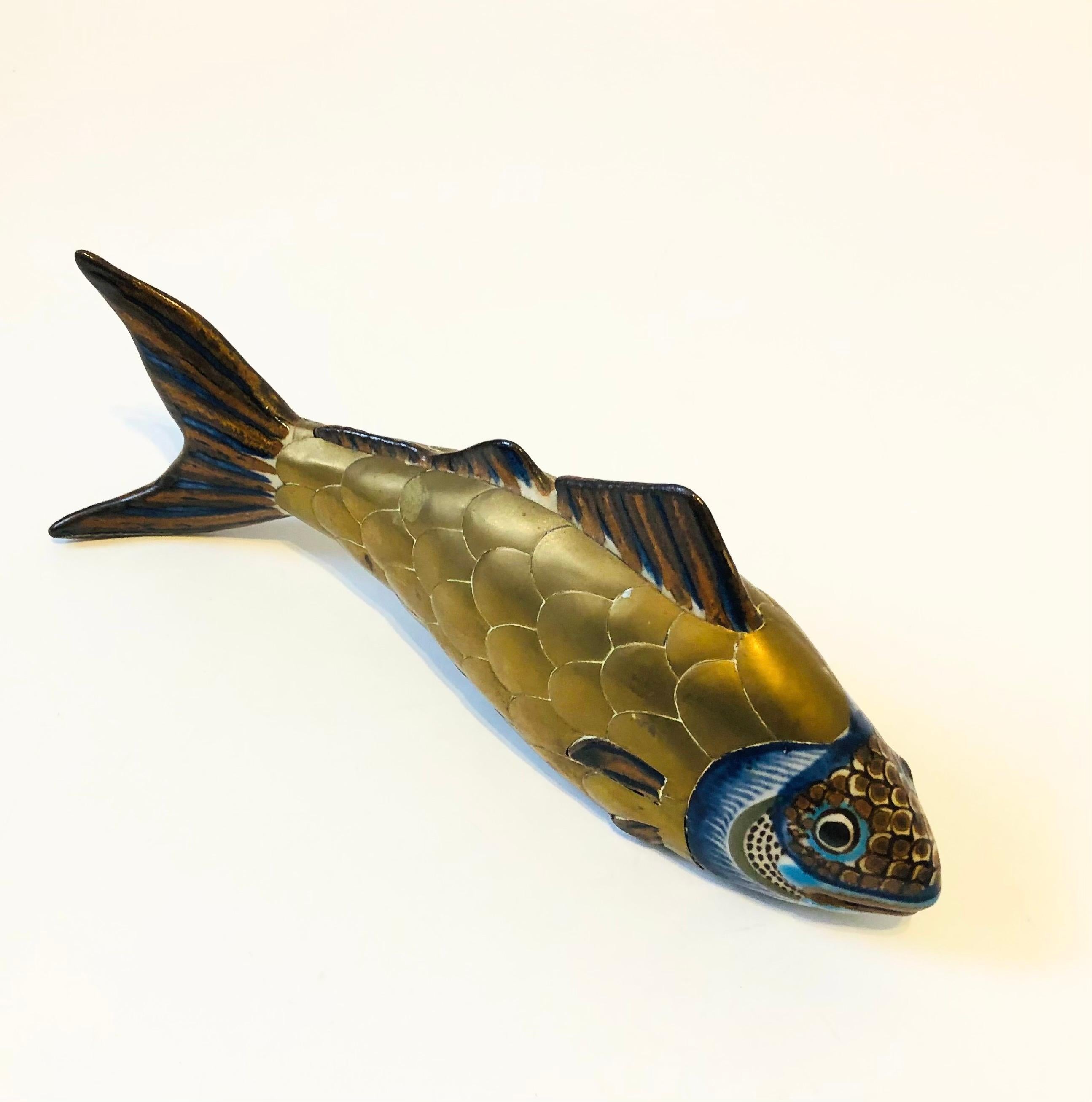 Un magnifique poisson vintage en poterie tonala enveloppé de laiton. Fabriqué au Mexique, avec de magnifiques motifs peints à la main sur la poterie et des écailles de poisson formées dans le laiton.

