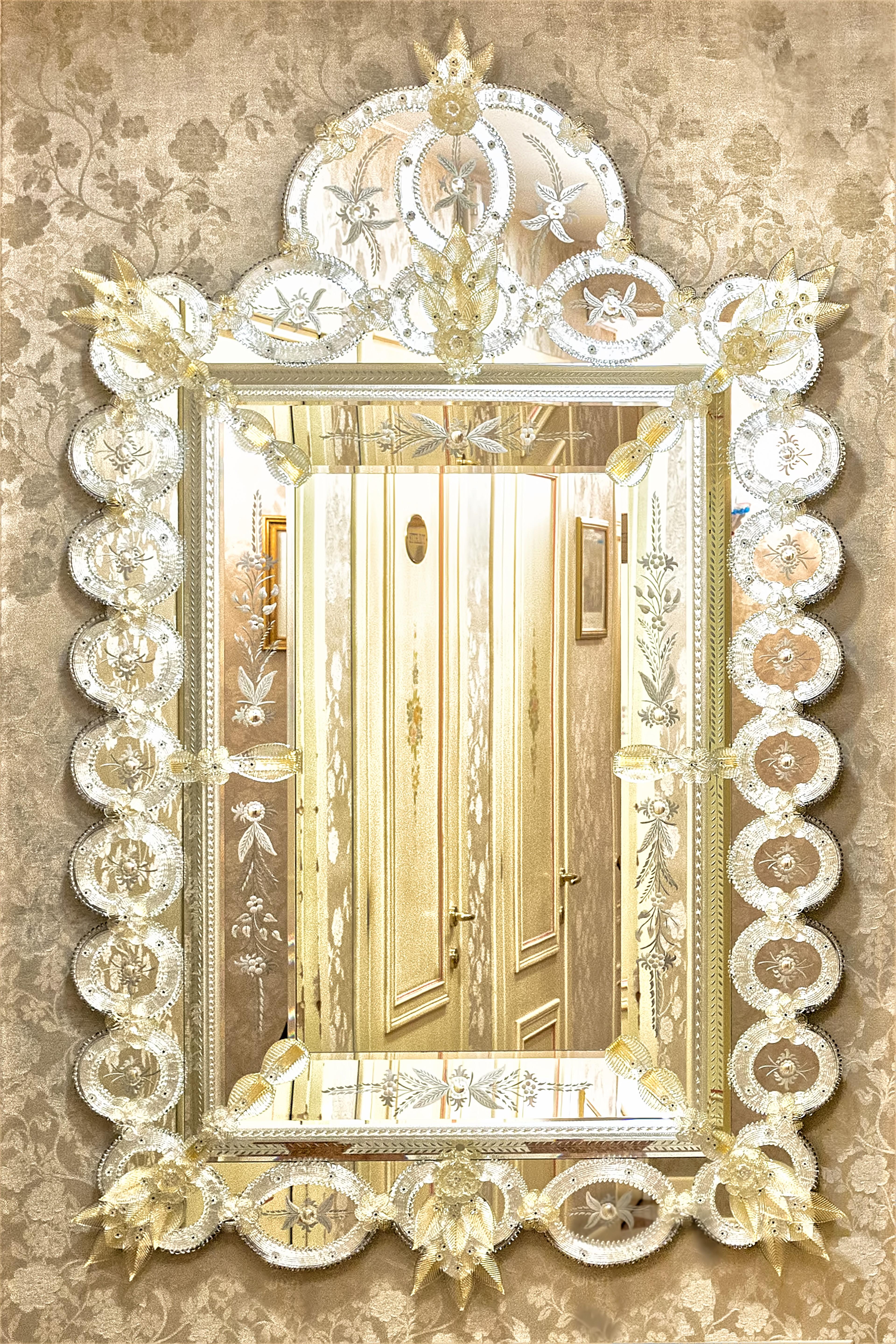 Luxurius Murano glass mirror in Venetian style, produced by Fratelli Tosi in the island of Murano in silver color with gold flower and leaves finishing, engraved, beveled and worked entirely by hand according to the Murano tradition, .
A Luxurious
