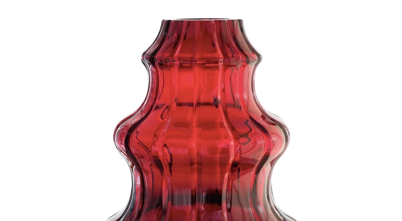 Part of the Boboda collection, this red crystal vase embodies passion. Either alone or displayed alongside power and love, the other two pieces that complete this charming trio, this exquisite object will make a refined statement in any room of the