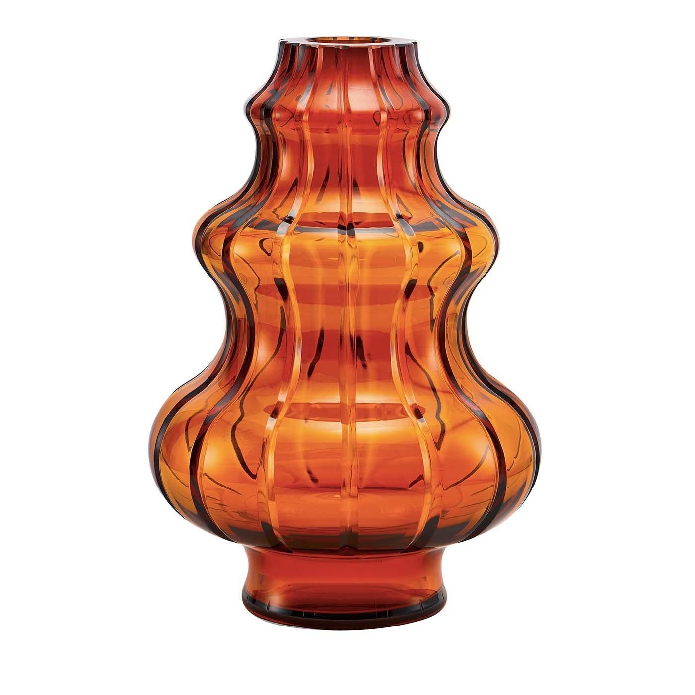 Part of the Boboda collection, this stunning vase is a superb decorative addition to any home and can be displayed alone or combined with the others in the same series. Its sinuous volumes in crystal with a delicate cognac color are marked with a