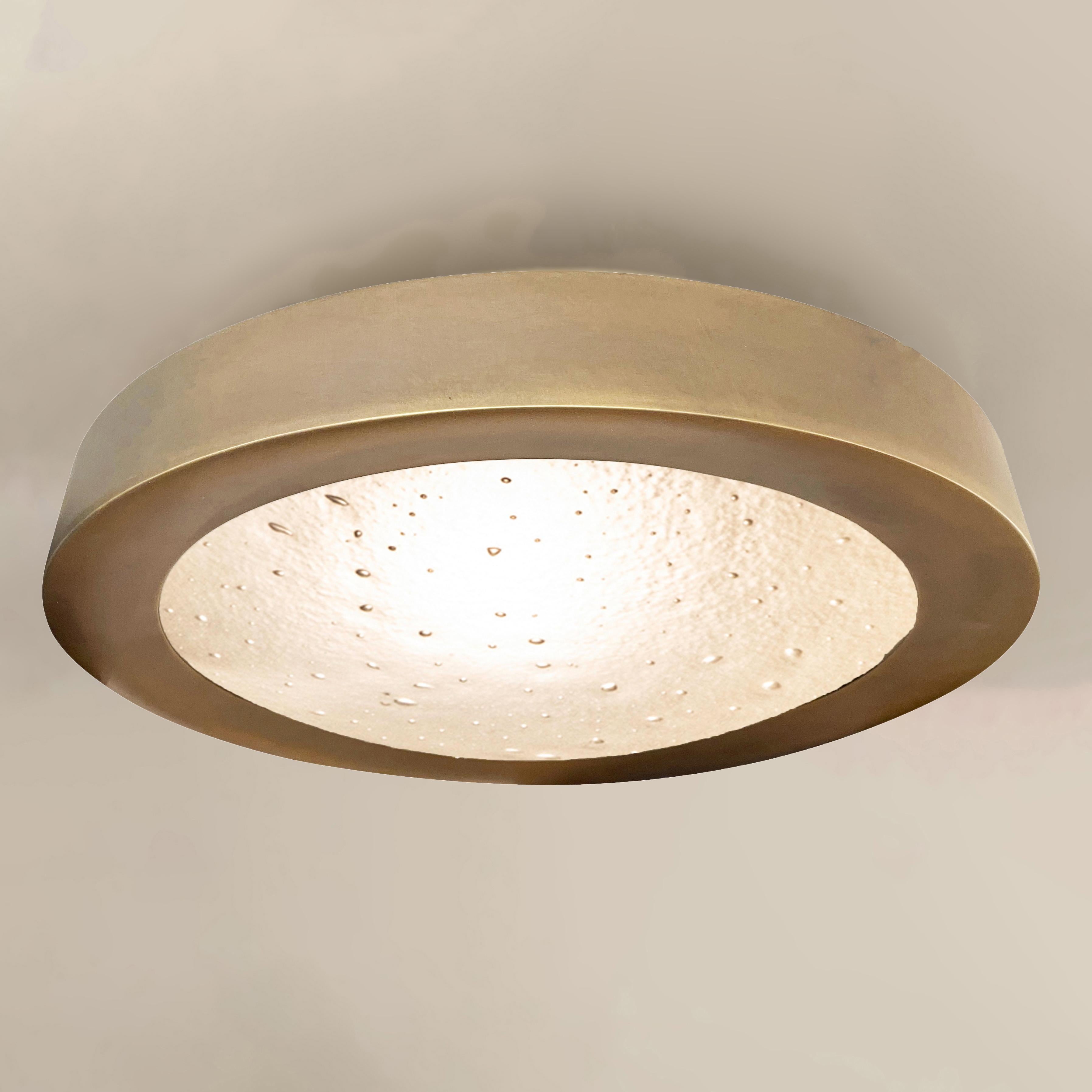 The Tondo Grande flush mount was designed to elavate smaller and low clearance spaces with its 4” drop. The concave bevel holding the convex Murano glass shade and its offset stance make it a highly sculptural piece despite its size. Shown in our