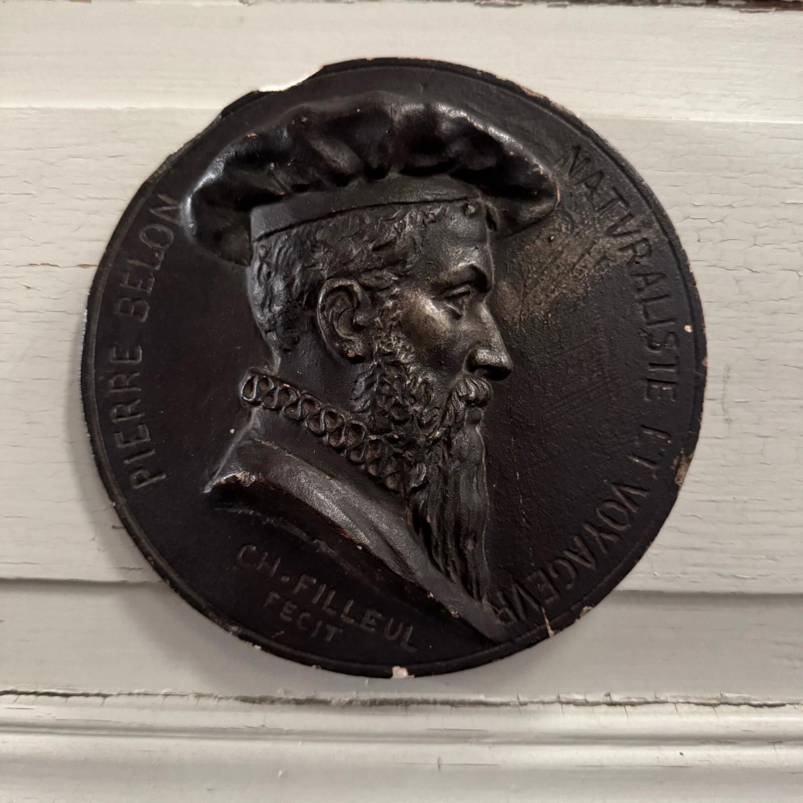 This medallion comes from the studio of Charles Filleul. It bears his signature and the inscription “Pierre Belon, naturalist and traveler.” The medallion has a patinated finish, and the hand-modeling is clearly visible.

In terms of condition,