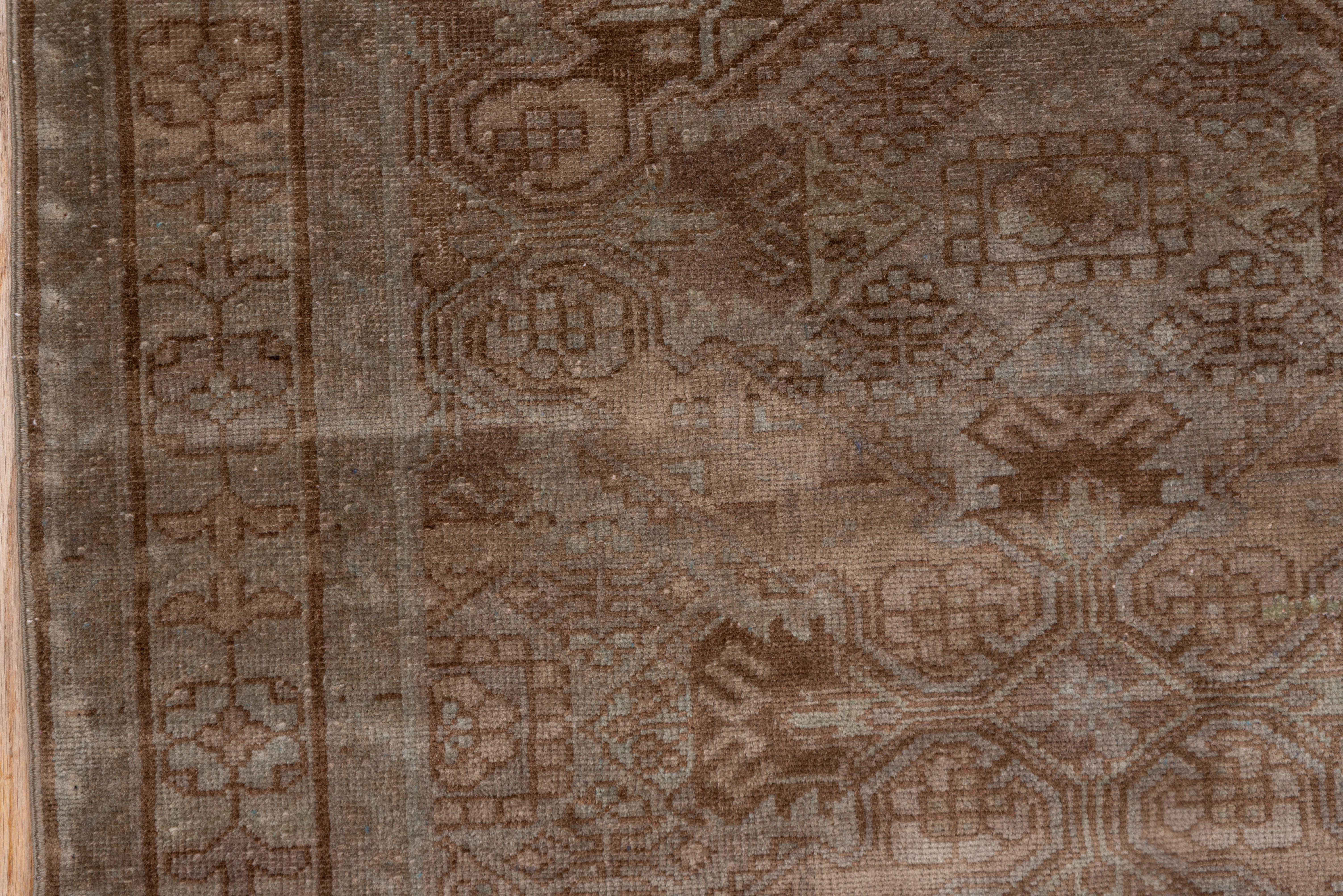 This rusitc lookingwest Persian small Malayer runner shows a Caucasian Zeychur Kurba pattern of St. Andrew's crosses on a tan ground. Reversing flower module border. General earth tone palette. Moderate weave on cotton. Brown tones.
 