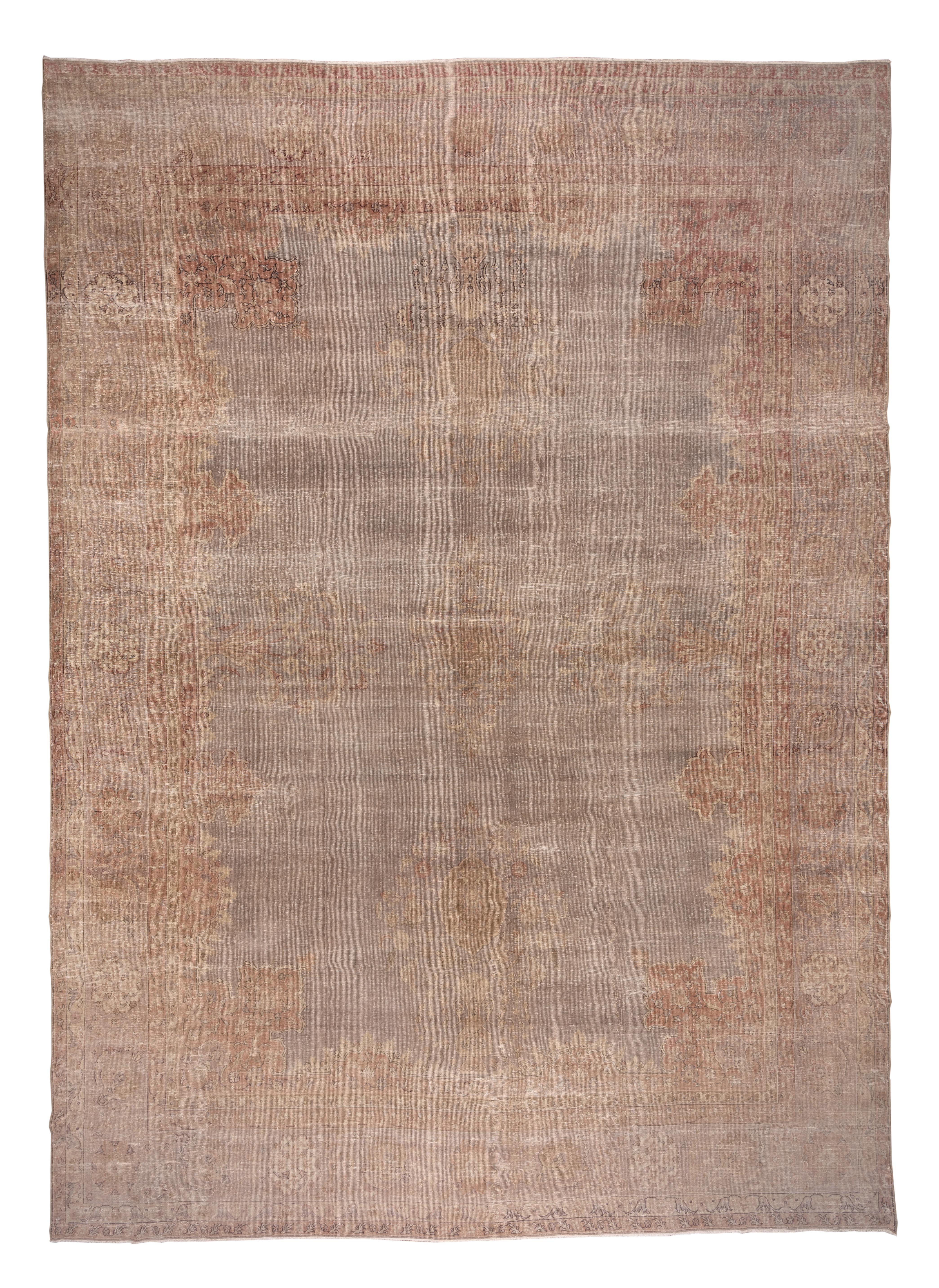 This substantially worn east Anatolian carpet presents vases at the cardinal points of the field. Tone-on-tone effect continues to the tan border with eggshell octofoils. There are a few accents in dark brown.