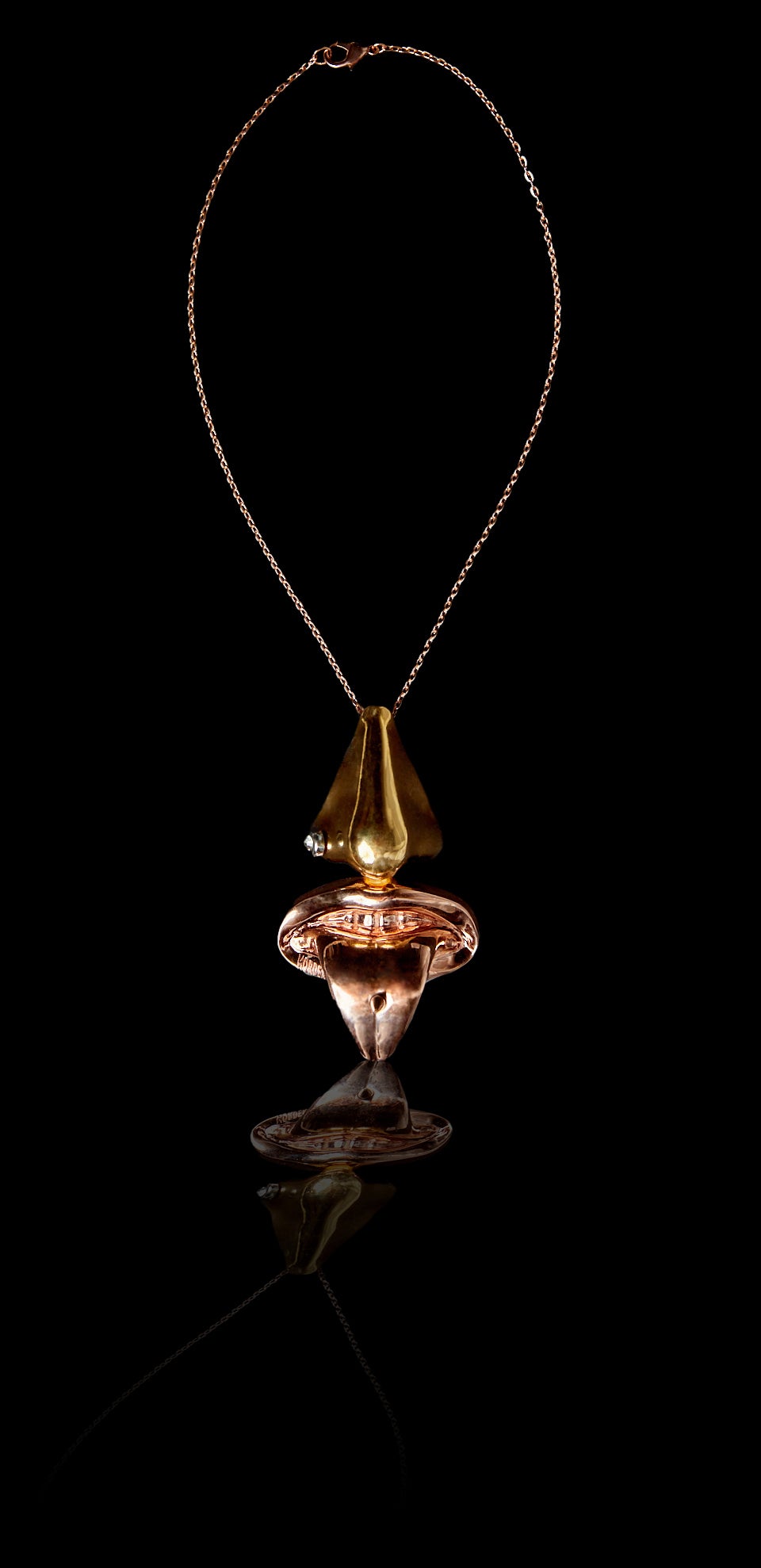 Inspired by the Dali perfume bottle, this pendant is the most unique conversation and statement neckpiece you will ever own. Constructed of our creative director’s face, it is a nose adorned with a crystal stud, and a tongue adorned with spike.