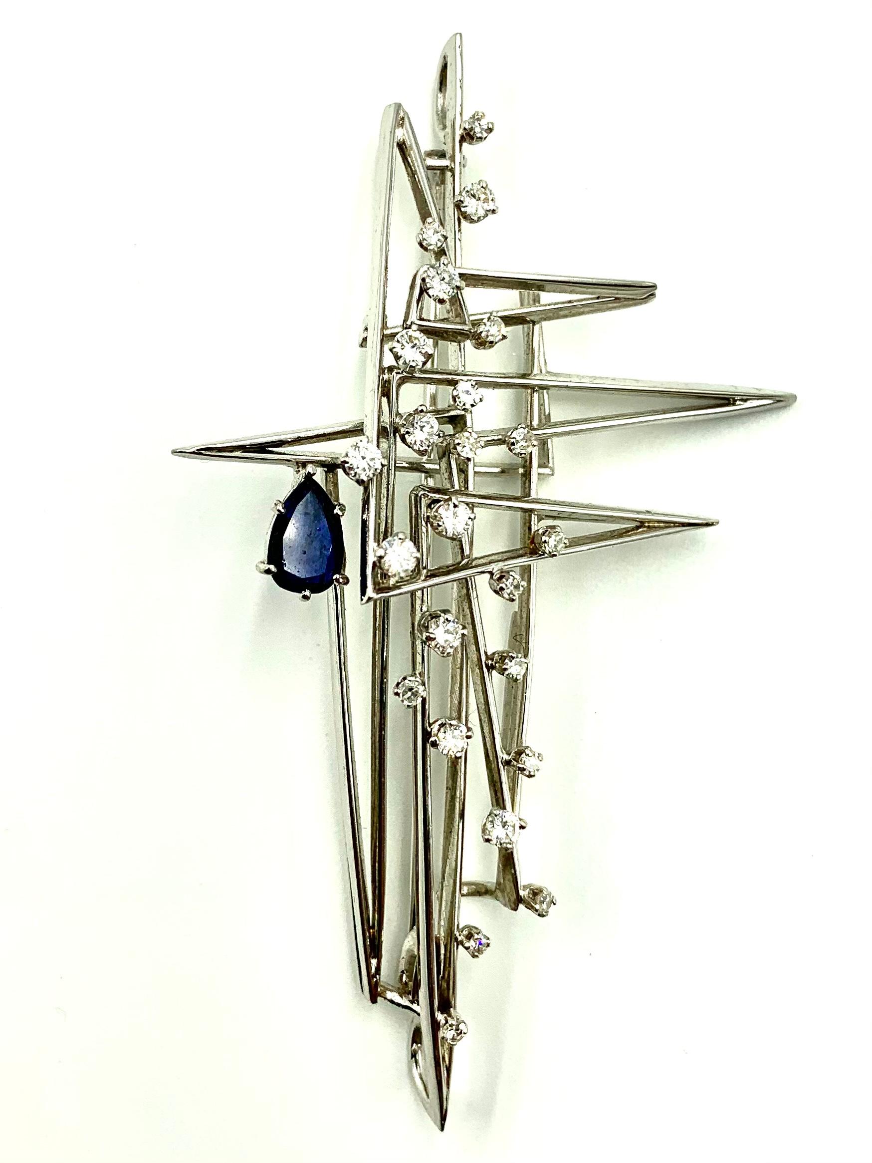 The sea, once it casts its spell, holds one in its net of wonder forever- Jacques Yves Cousteau

Modern, large, stylized nautical motif diamond, sapphire and 18K white gold pendant/brooch in the shape of a three mast yacht atop a drop shaped blue