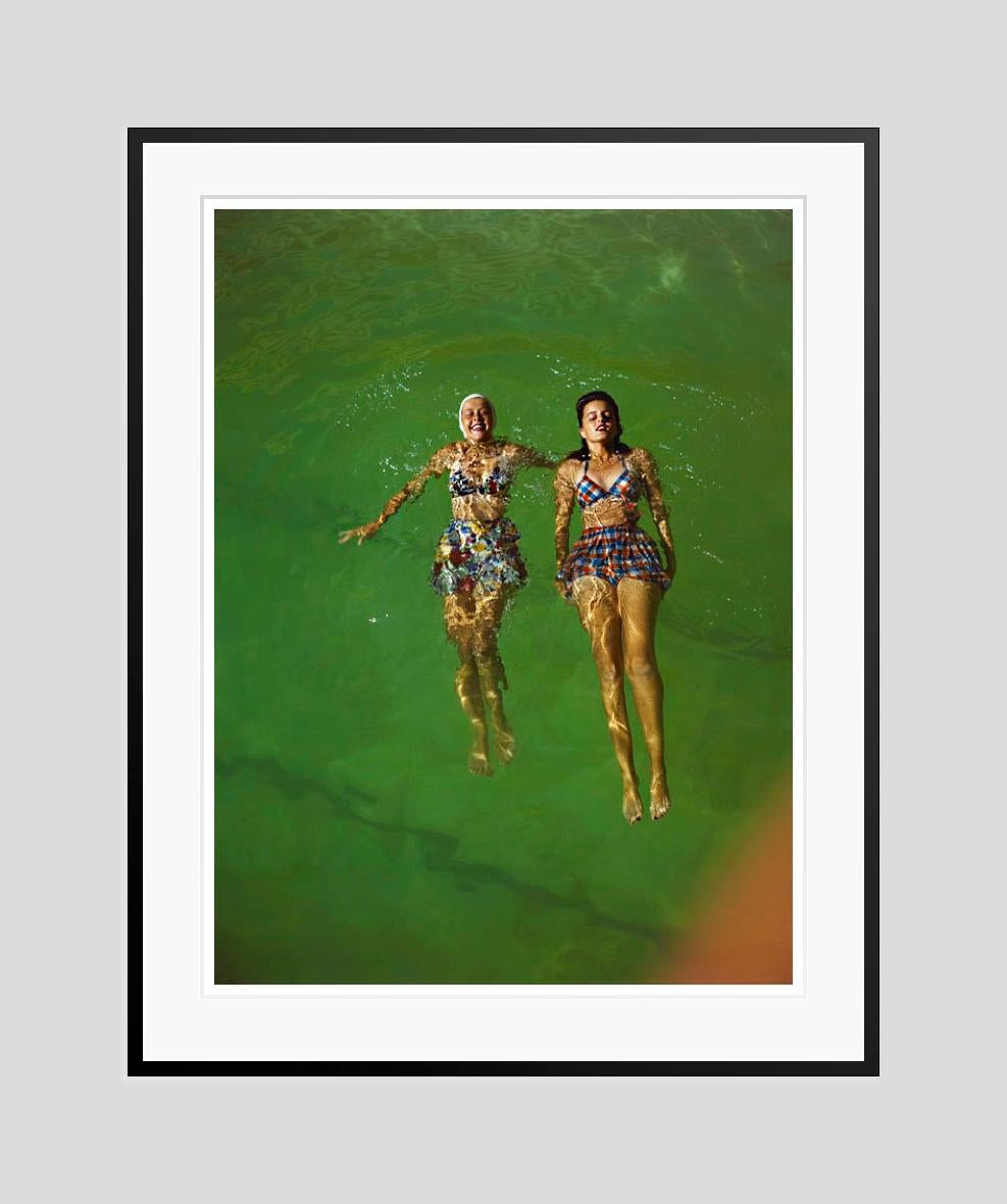 Floating
1960

Two women in swimwear float on water.
by Toni Frissell

40 x 30