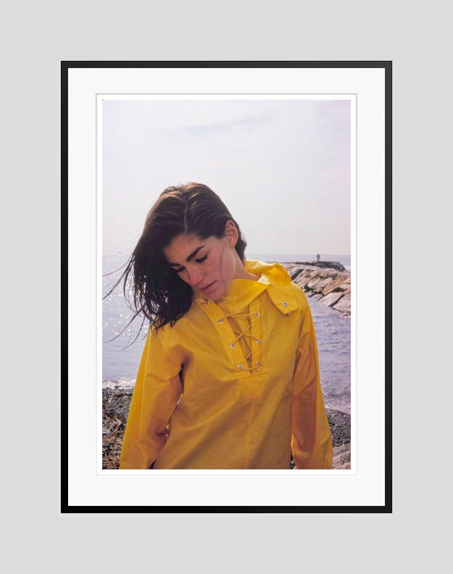 Minnie Cushing In Yellow 

1965

Model Minnie Cushing wearing a yellow waterproof jacket stands by the ocean, 1965

by Toni Frissell

20 x 24