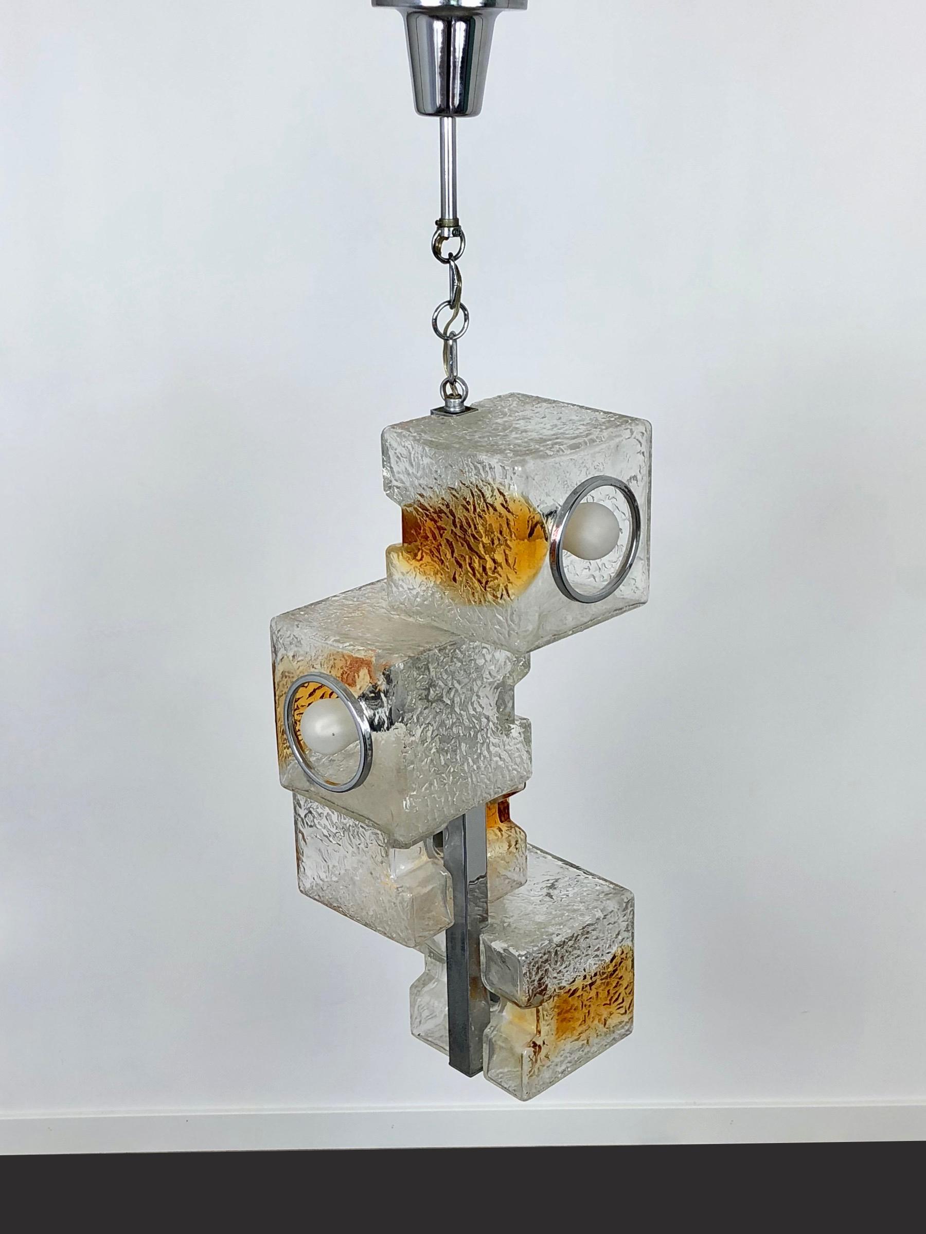 Chandelier pendant by Toni Zuccheri for VeArt 1970s Murano art glass. It features four lights placed inside four design cube in amber Murano glass. The pendant is in chrome.