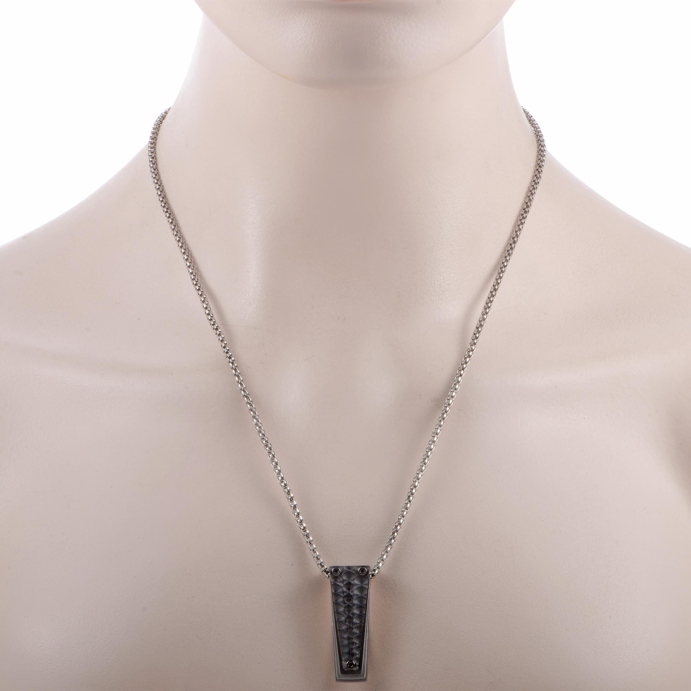 The Tonino Lamborghini “Motore Collection” necklace is crafted from stainless steel and weighs 27.4 grams. The necklace is presented with a 20” chain and a pendant that measures 1.50” in length and 0.50” in width.

Offered in brand new condition,