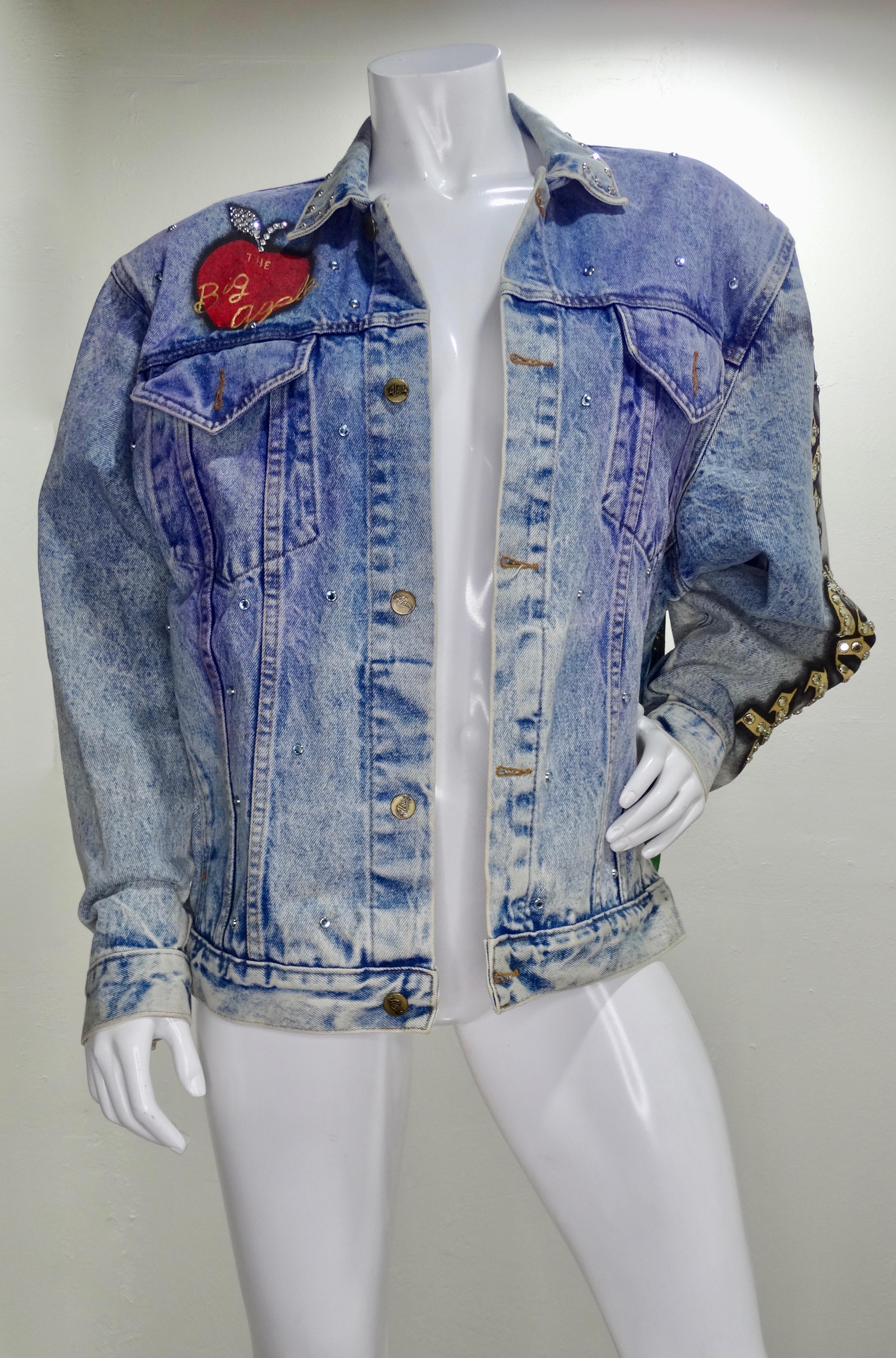 Feel like the ultimate New Yorker with this Tony Alamo jean jacket! Circa 1987, this oversized jean jacket features an acid wash, blue/green/purple airbrushing, brass toned buttons, two front pockets and eye-catching rhinestone embellishing