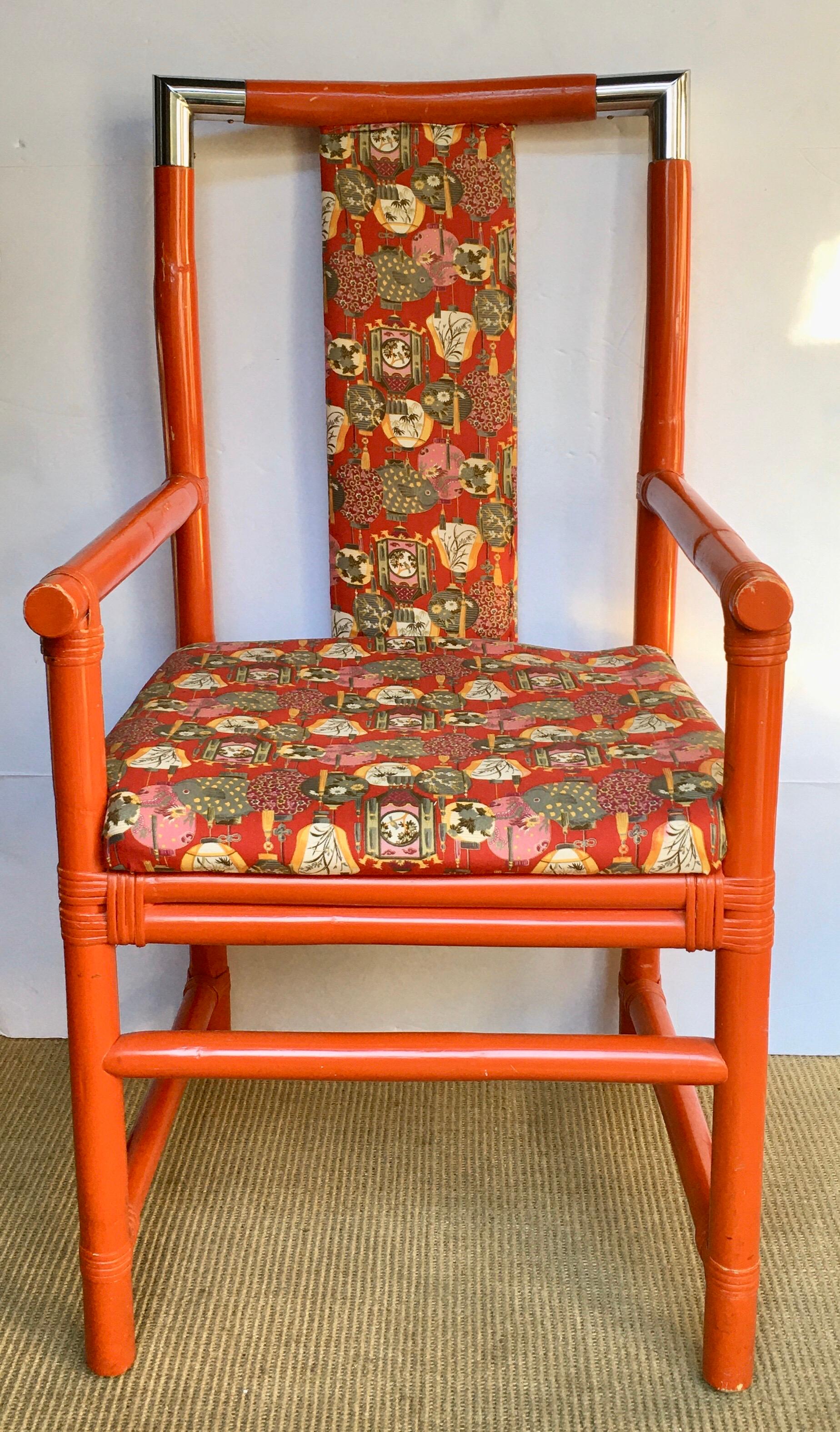 Mid-Century Modern vibrant orange painted wood bamboo accent chair with metal chrome accents. Chair frame is constructed of thick sturdy bamboo reeds connected by polished chrome corner end caps. Upholstered in an Asian motif upholstery. A perfect
