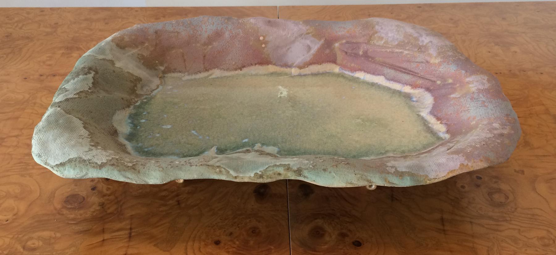 Large art pottery tray with a rattan base. Made by Evans Ceramics of California.
Titled Ancient sands comes with the original numbered paper describing the company etc. Measures: 22 inches wide by 16 deep 4.5 high makes a great center piece for a