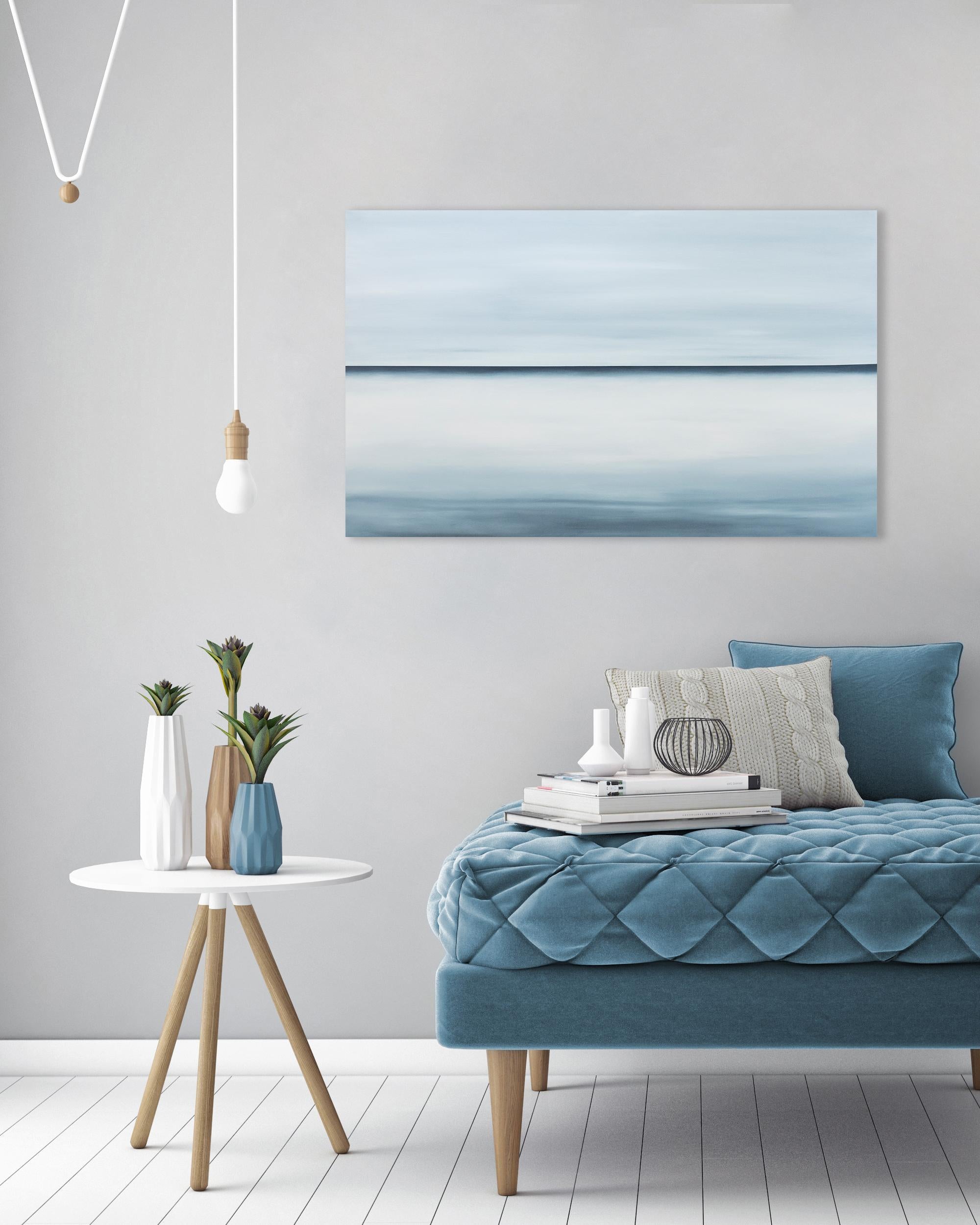 This abstract oil painting by Tony Iadicicco features a blue monochromatic palette. The painting has an abstracted landscape composition, with a stark blue horizon line running through the center of the canvas and soft blue blended colors above and