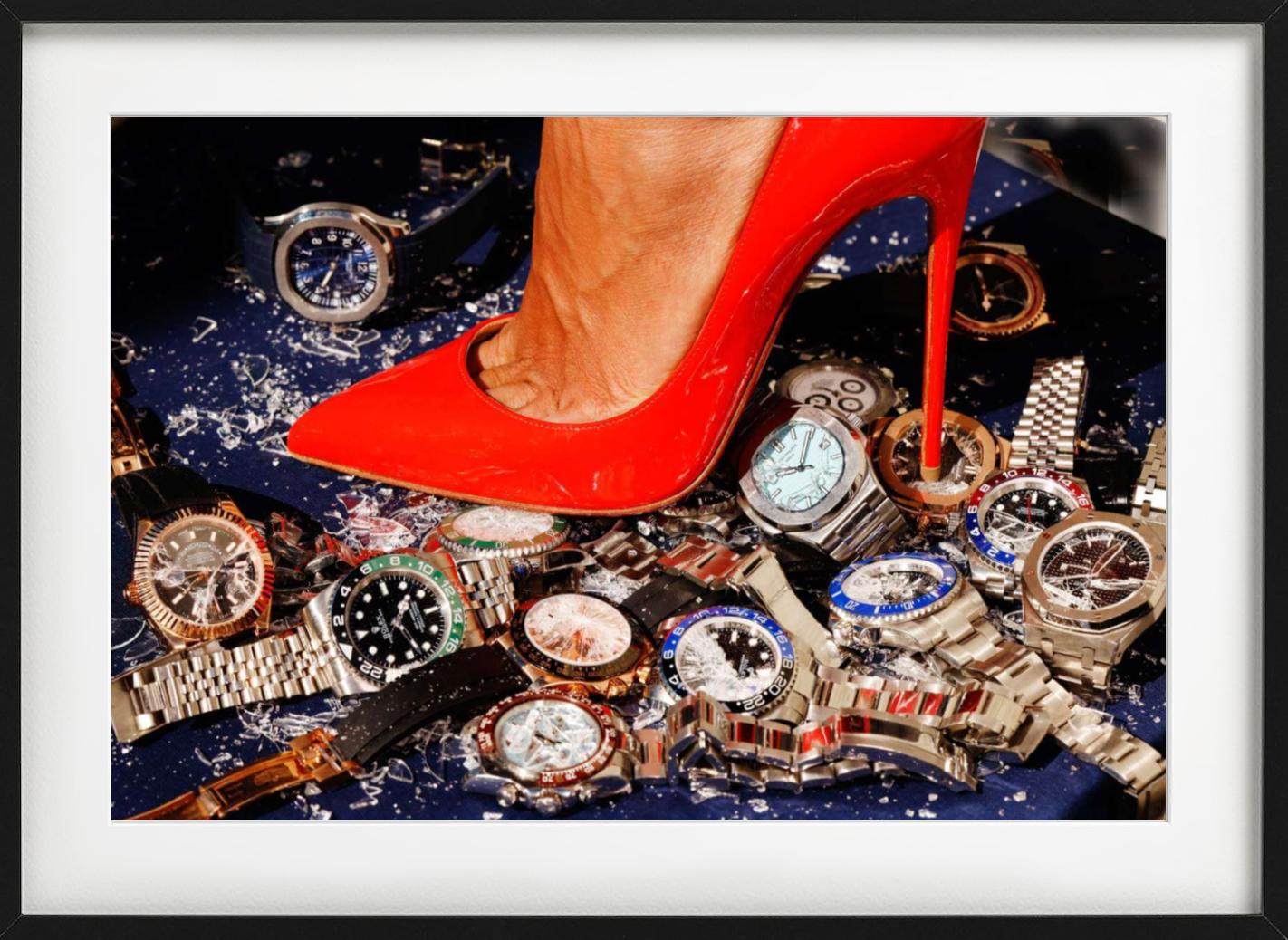 Up & Up - primo piano di un tacco rosso che schiaccia alcuni Rolex, Fine Art Photography - Color Photograph Nero di Tony Kelly