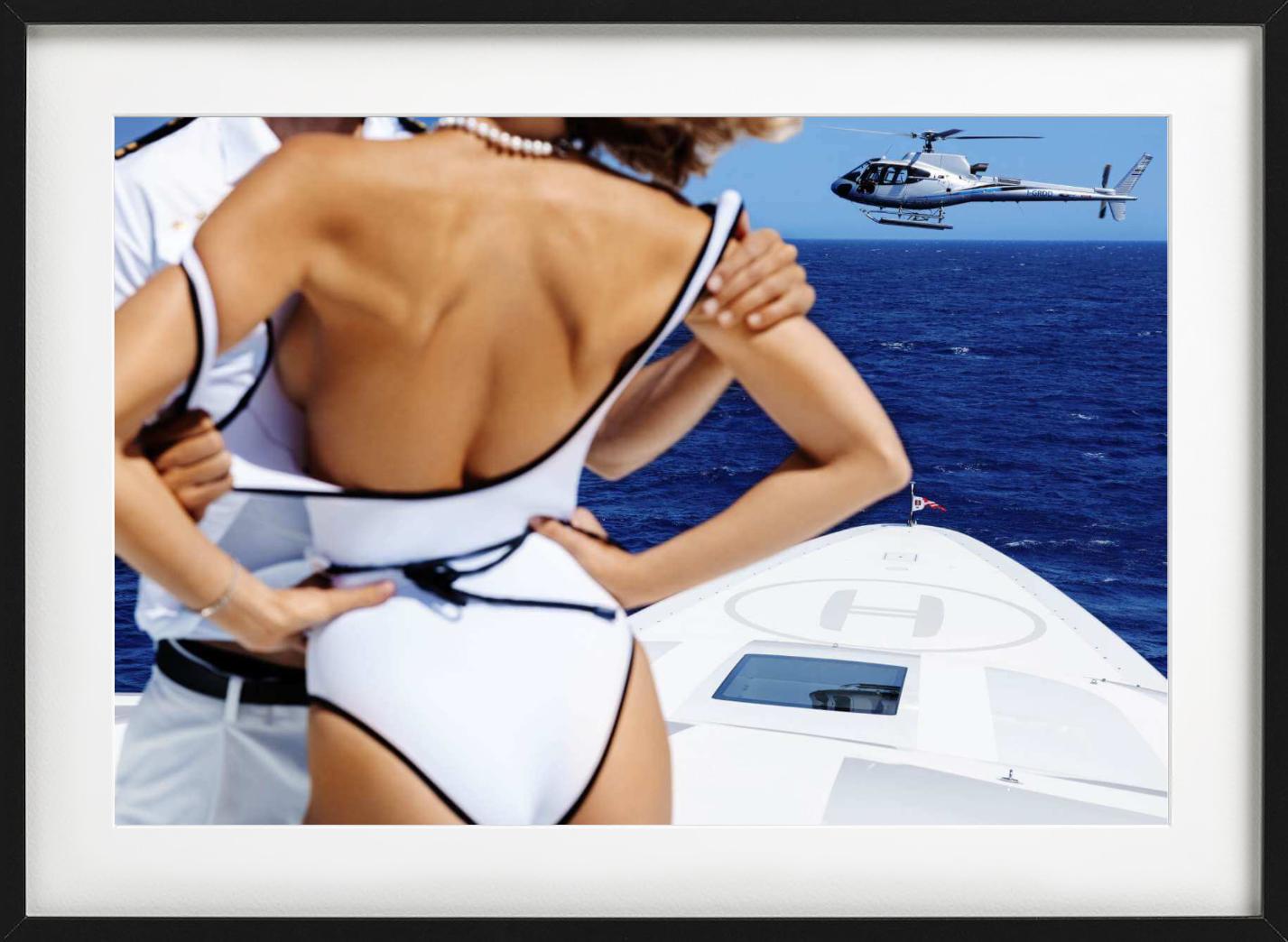 Woman and Officer in embrace on a Boat, with a helicopter in the background photographed by Tony Kelly.

All prints are limited edition. Available in multiple sizes. High-end framing on request.

All prints are done and signed by the artist. The