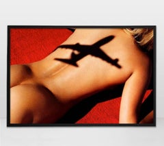 Flight 5 - nude portrait of a woman sunbathing overshadowed by an airplane