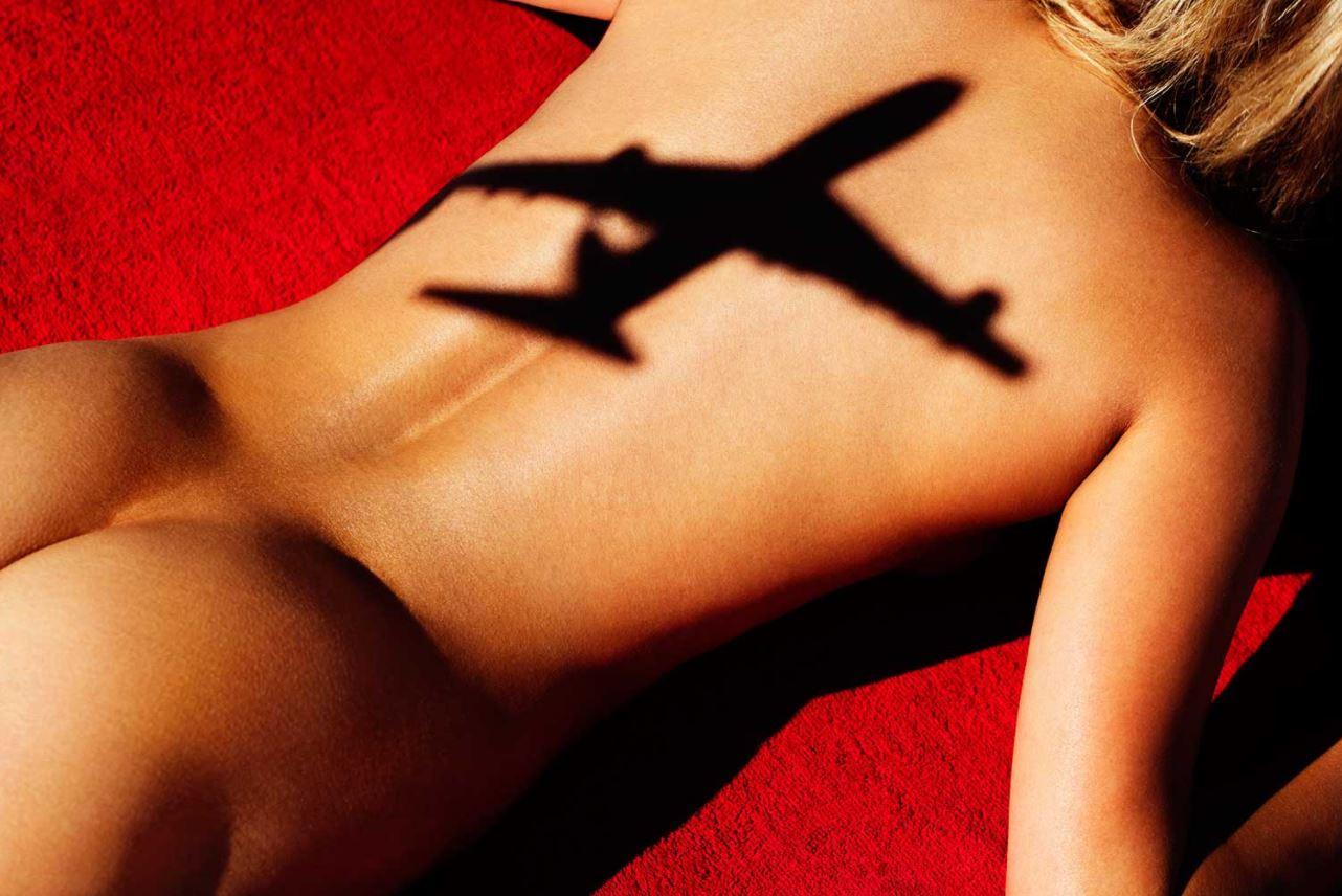 Tony Kelly Nude Photograph - Flight 5, sunbathing woman overshadowed by an airplane, Fine Art Photography