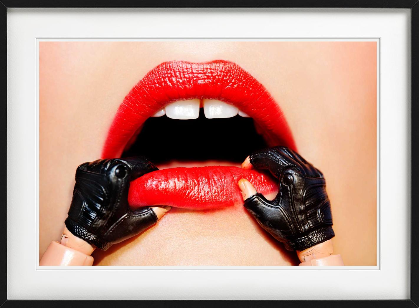 Puppenhände, die scheinbar nach den Lippen eines Menschen greifen, um in einen Mund zu gelangen, fotografiert von Tony Kelly. 

Alle Drucke sind in limitierter Auflage erhältlich. Erhältlich in mehreren Größen. Hochwertige Einrahmung auf