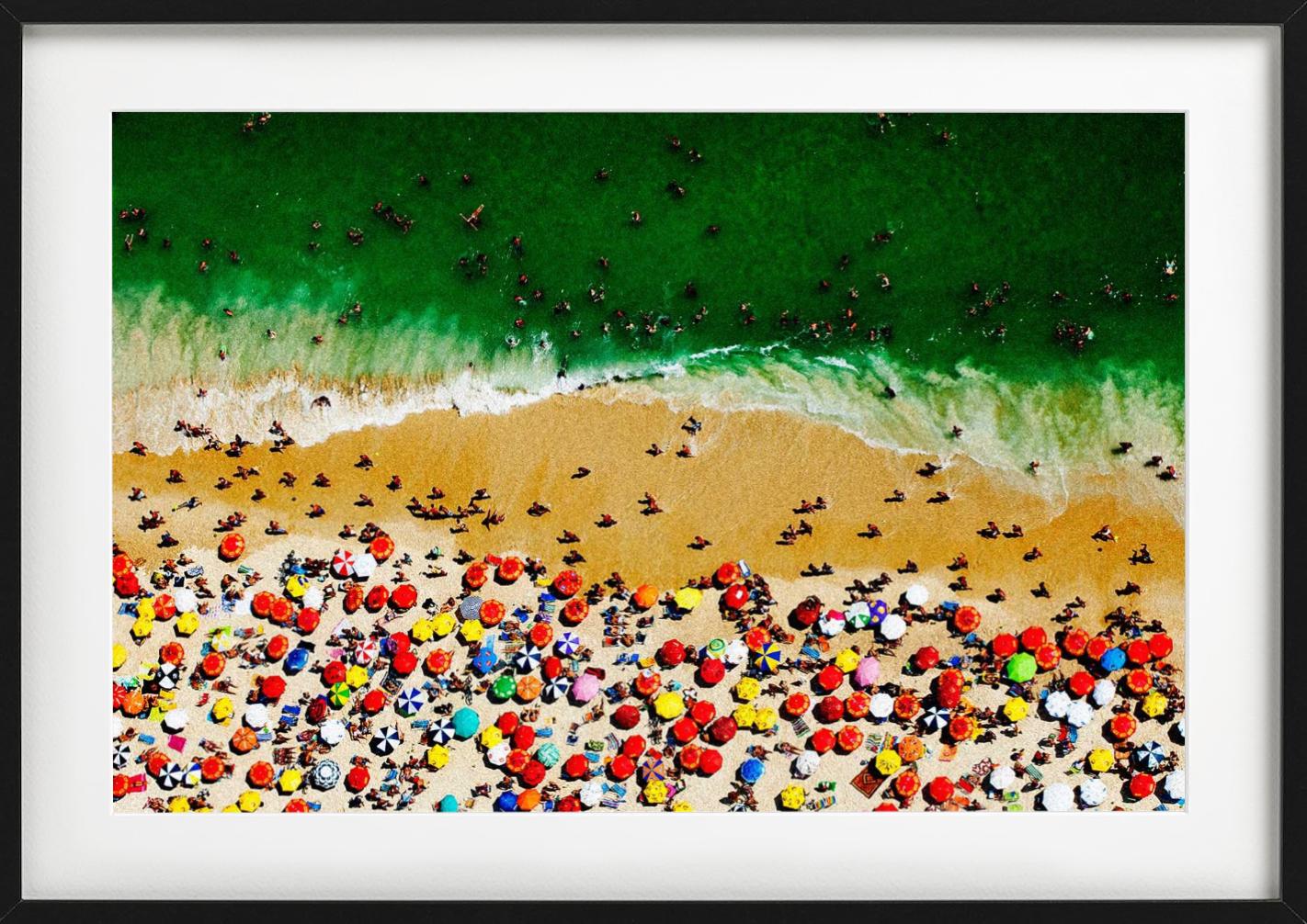 Rio Aerial by Tony Kelly - The beach of Rio de Janeiro filled with colorful parasols is shown from a birds-eye view.

All prints are limited edition. Available in multiple sizes. High-end framing on request.

All prints are done and signed by the