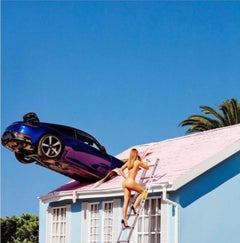 Rooftop Parking - naked model climbing on a rooftop with a car