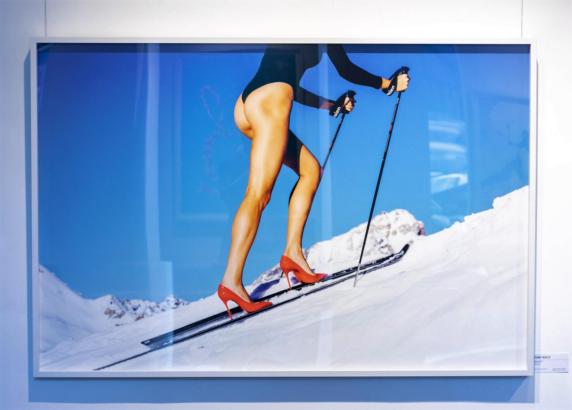 Backcountry  - model skiing with high heels and mountains in the background - Photograph by Tony Kelly