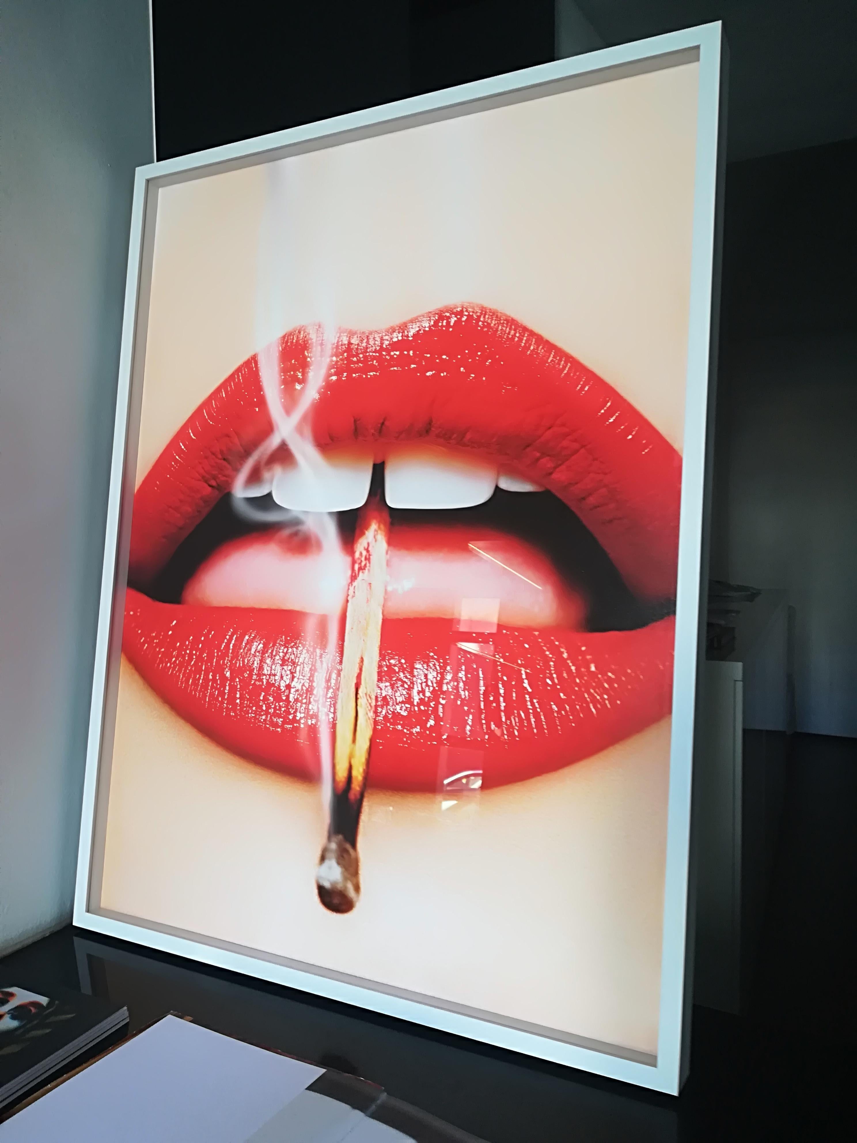 Smoking Lips - 2013 Playboy Cover of Red Lips with a Burning Match (Lèvres rouges avec une allumette enflammée), fine art - Orange Figurative Photograph par Tony Kelly