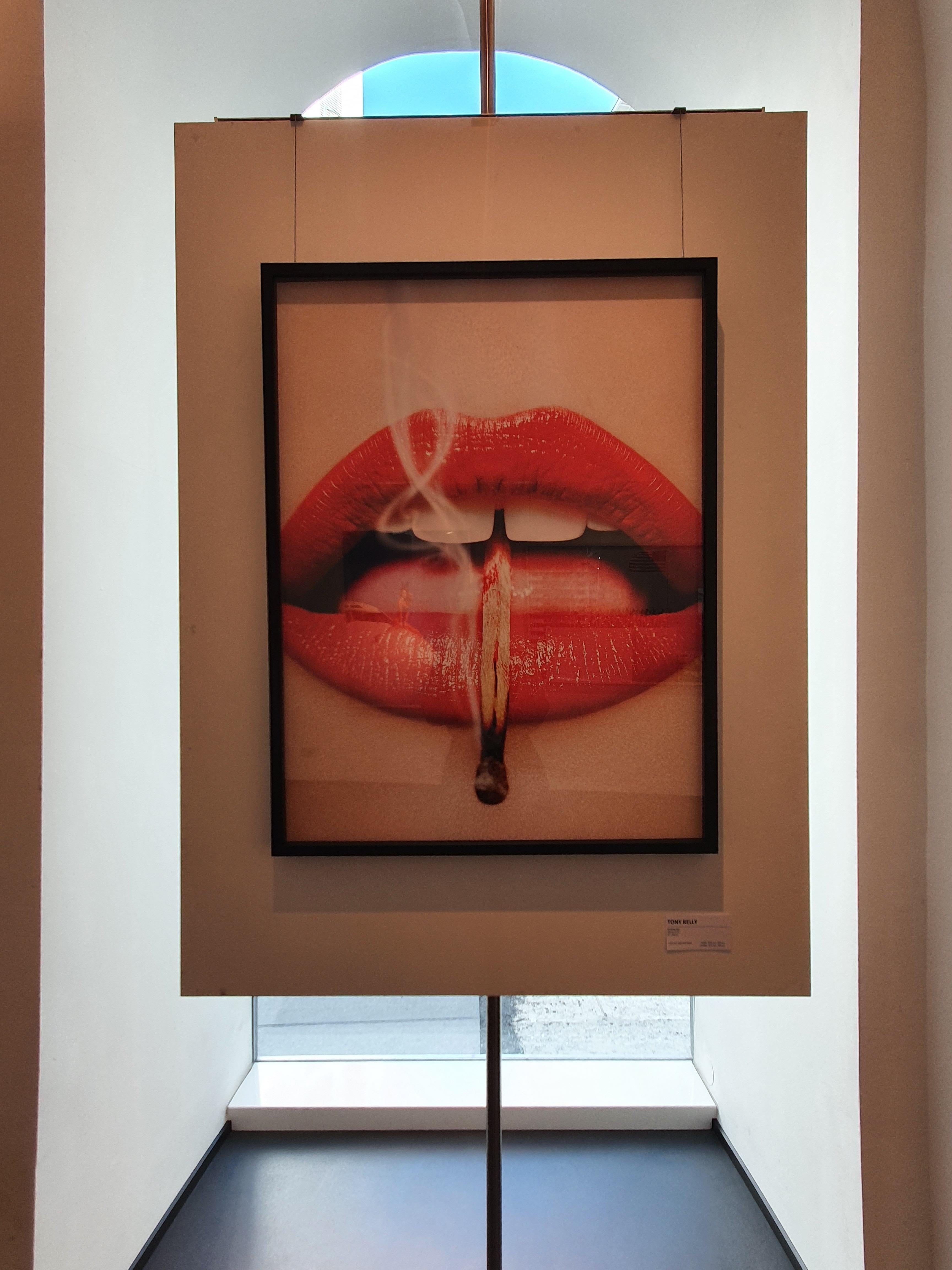 Smoking Lips - 2013 Playboy Cover of Red Lips with a Burning Match, fine art - Contemporary Photograph by Tony Kelly