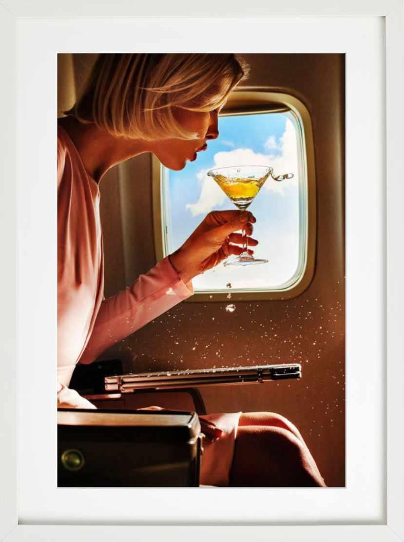 Turbulence - woman spilling champagne in an airplane, fine art photography, 2019 - Brown Figurative Photograph by Tony Kelly