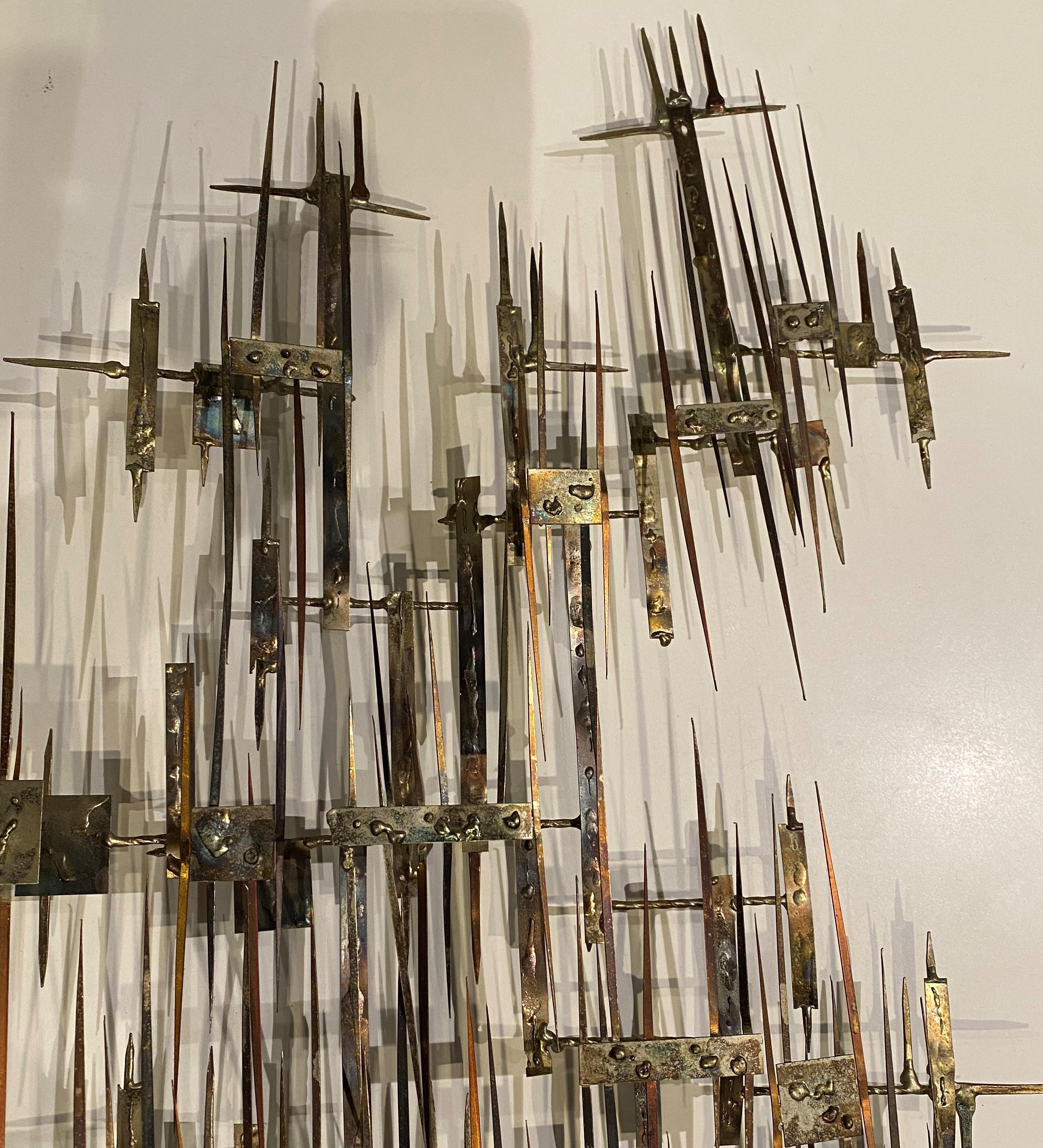 A wonderful abstract brutalist welded and torch cut steel wall sculpture with many points and a burnished finish, by 20th century California artist Tony Melendy, with a signature tag “Melendy” attached. Melendy was an accomplished artist, with