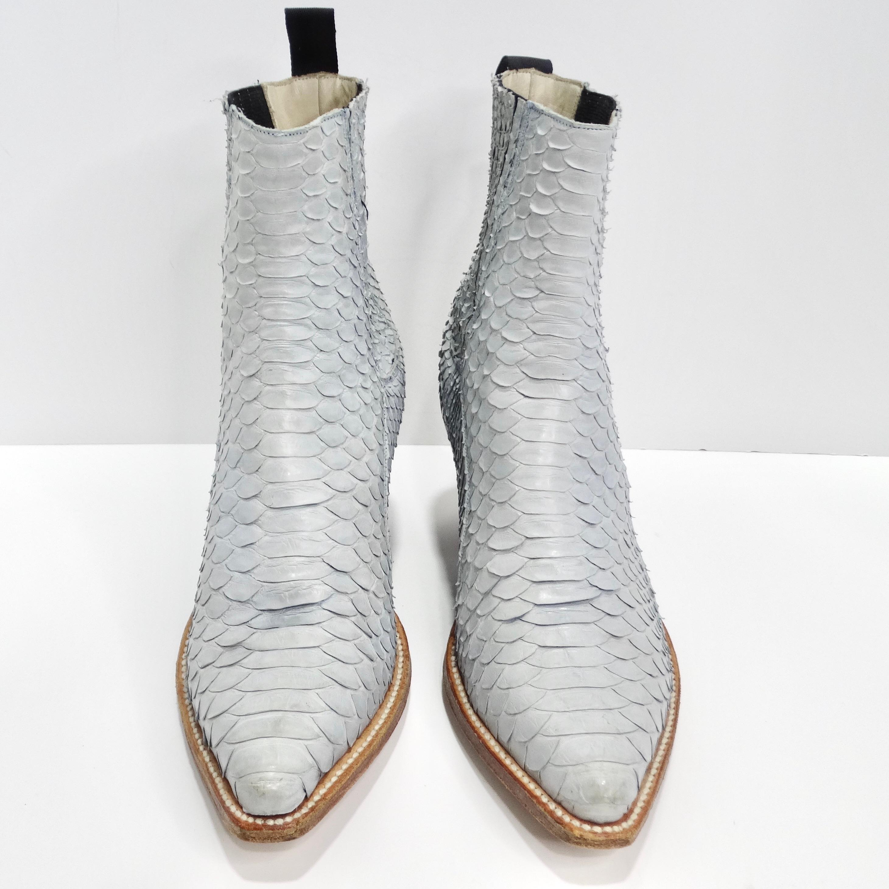 Step into the height of luxury with the Tony Mora Blue Python Ankle Boots. Crafted from genuine light blue python leather, these ankle boots exude opulence and sophistication. The unique texture and color of the python leather make these boots a
