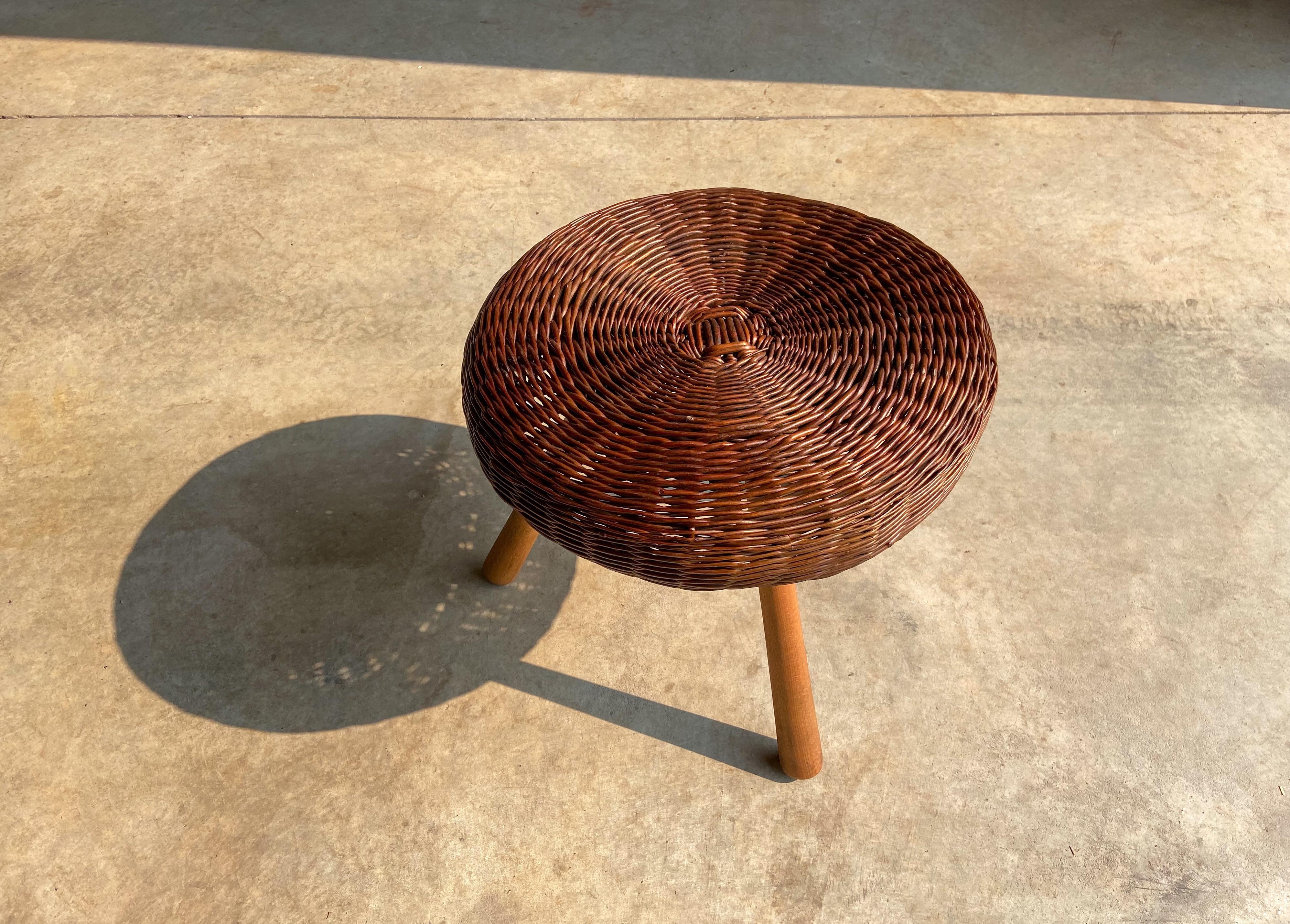A vintage rattan/wicker and wood stool attributed to Tony Paul. 

Featuring a hand woven rattan seat that sits upon a wood frame and solid birch legs.

This would make a perfect accent piece that is suitable in a variety of settings including