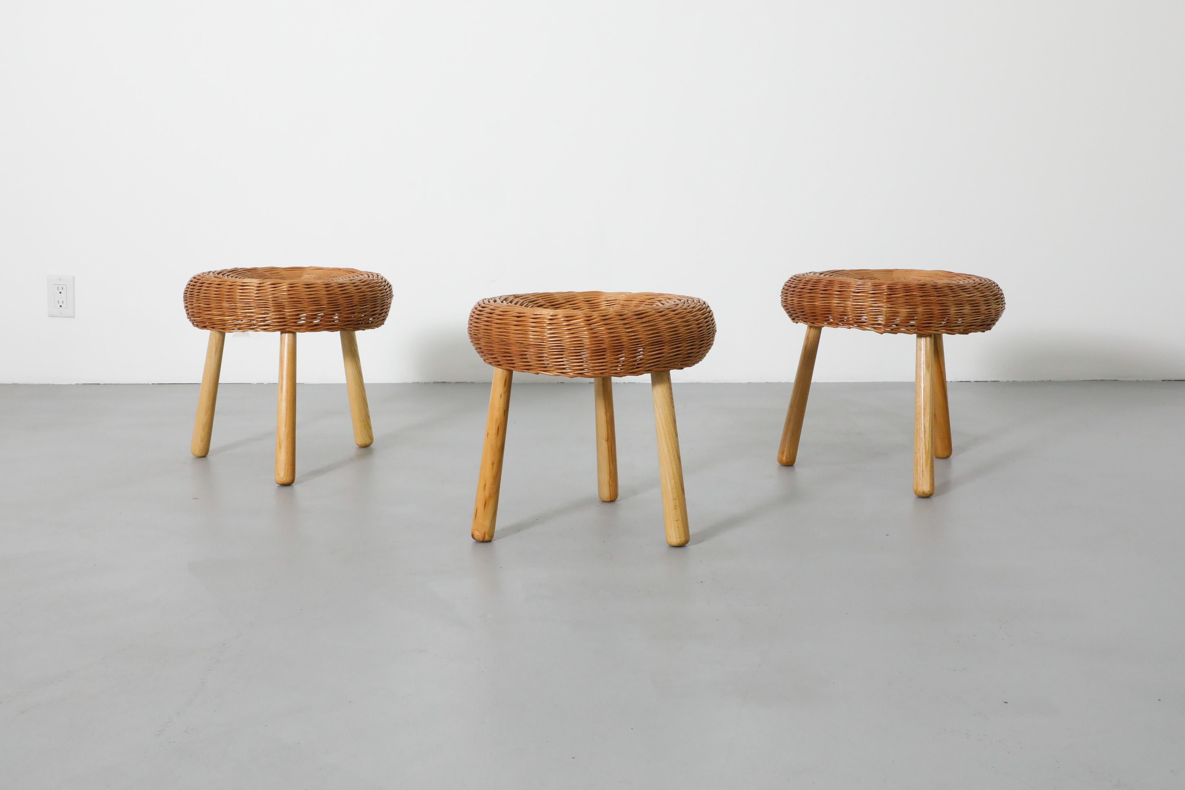 These beautiful Mid-Century stools are attributed to the American designer Tony Paul and were made in the former Yugoslavia in the 1950s, early 1960's. They have three attractively tapered legs made of llight brown wood and a round seat made of