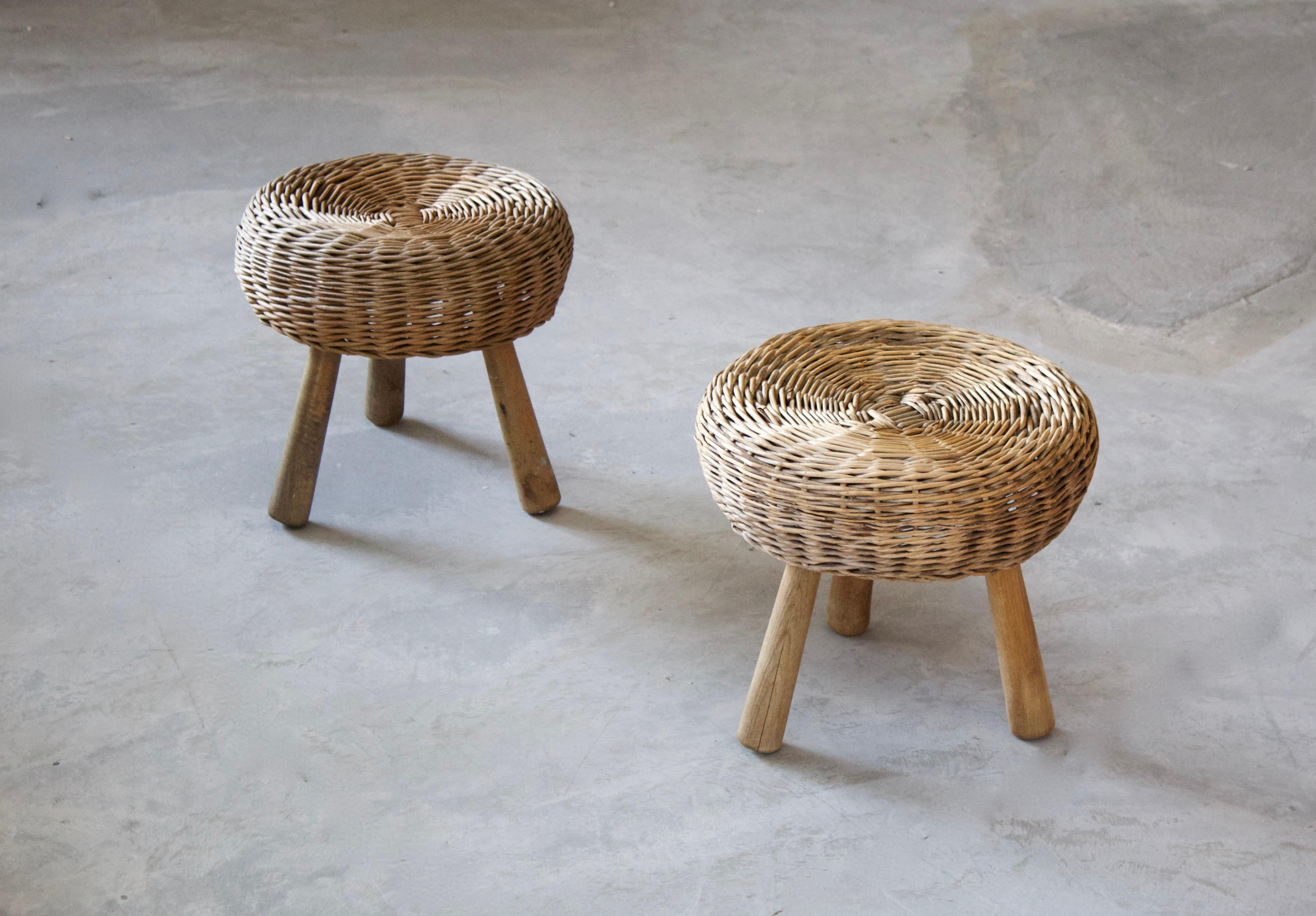 A pair of stools, design attributed to Tony Paul. Features an interesting mix of rattan and finely carved solid wood.

Other designers of Minimalist stools of the period include Charlotte Perriand, Pierre Chapo, Isamu Noguchi, Eero Arnio, and Sori