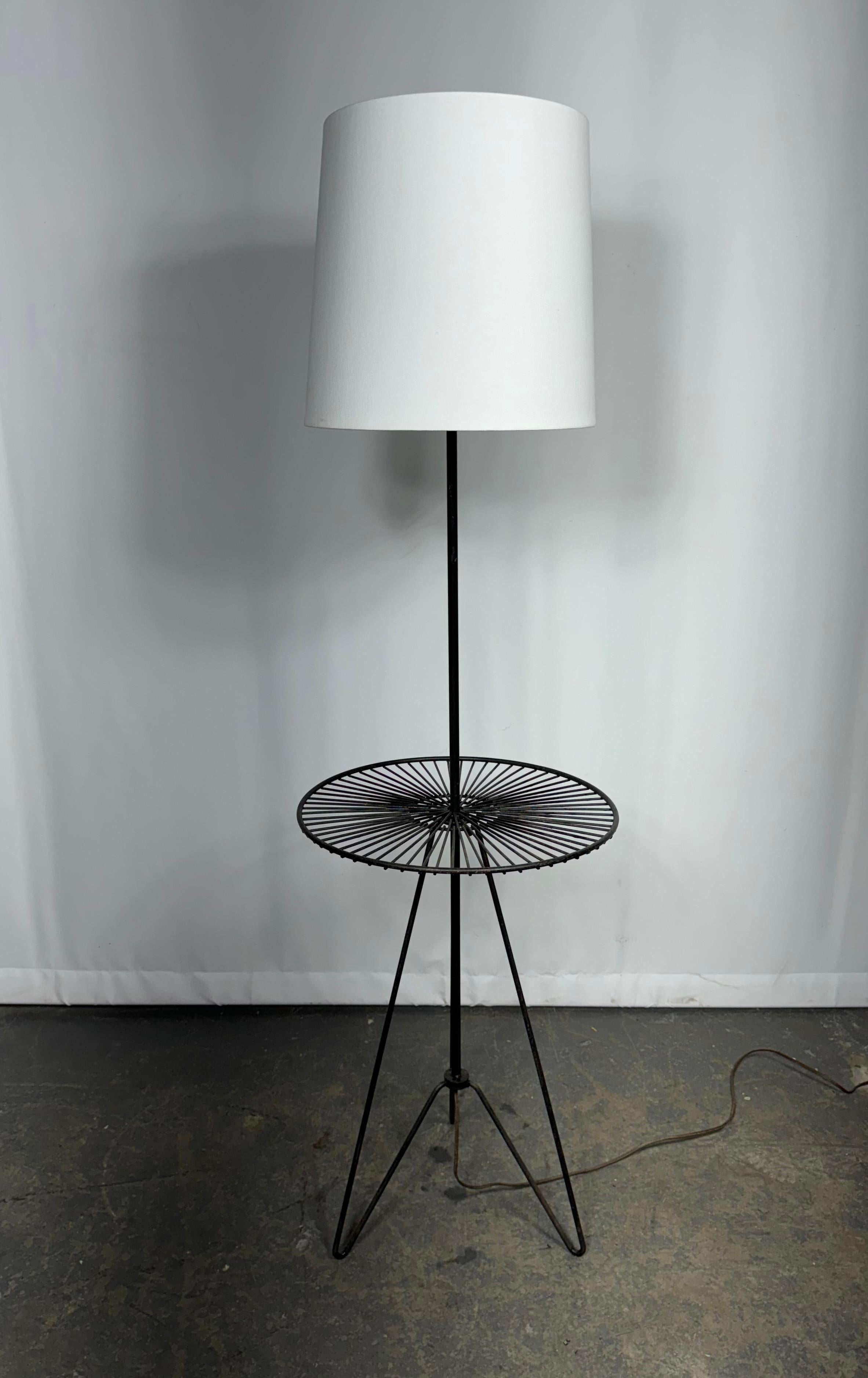 Tony Paul Black Wrought Iron and Black Wire Side Table and Floor Lamp. Featuring a Black Wrought Iron stem, round rimmed Black enameled wire surface on balanced tripod hairpin legs. Shade shown for display only. Sturdy. Lightweight. American