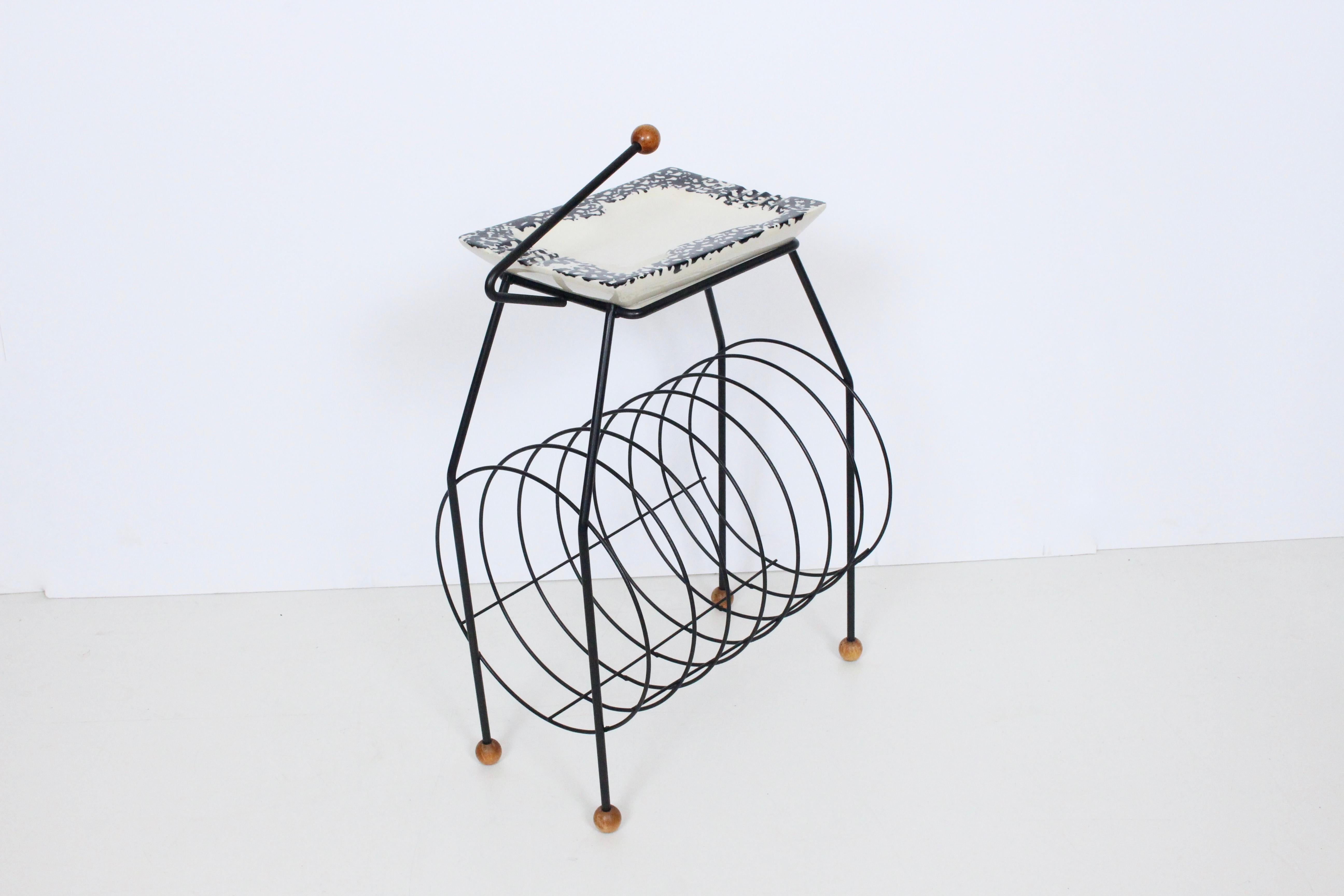 Tony Paul Atomic Record Stand, Smoking Stand with Ceramic Dish, Ashtray. Featuring a spiral Black Iron wire framework, cylindrical form, round wooden handle and feet, rectangular glazed Cream Stoneware tray (10.5W x 7.5D) with black abstract