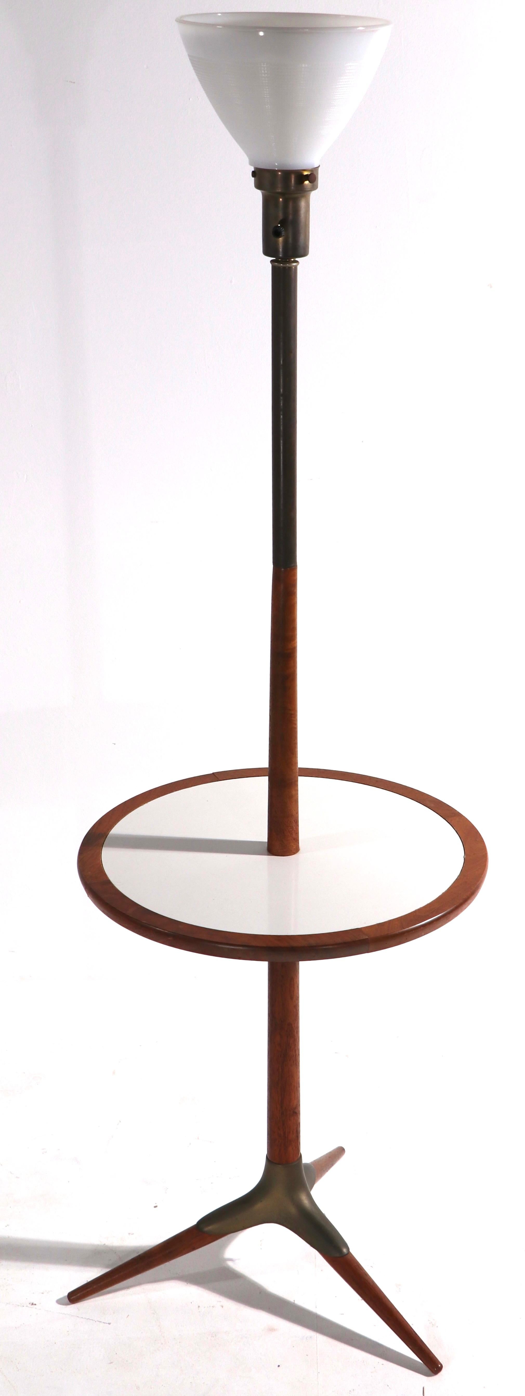 Rare and unusual floor lamp with center table surface by Tony Paul attributed to Westwood Industries. This example isn in very good, original condition, with exception of the wiring which is new. Exceptional mid century design by noted designer,