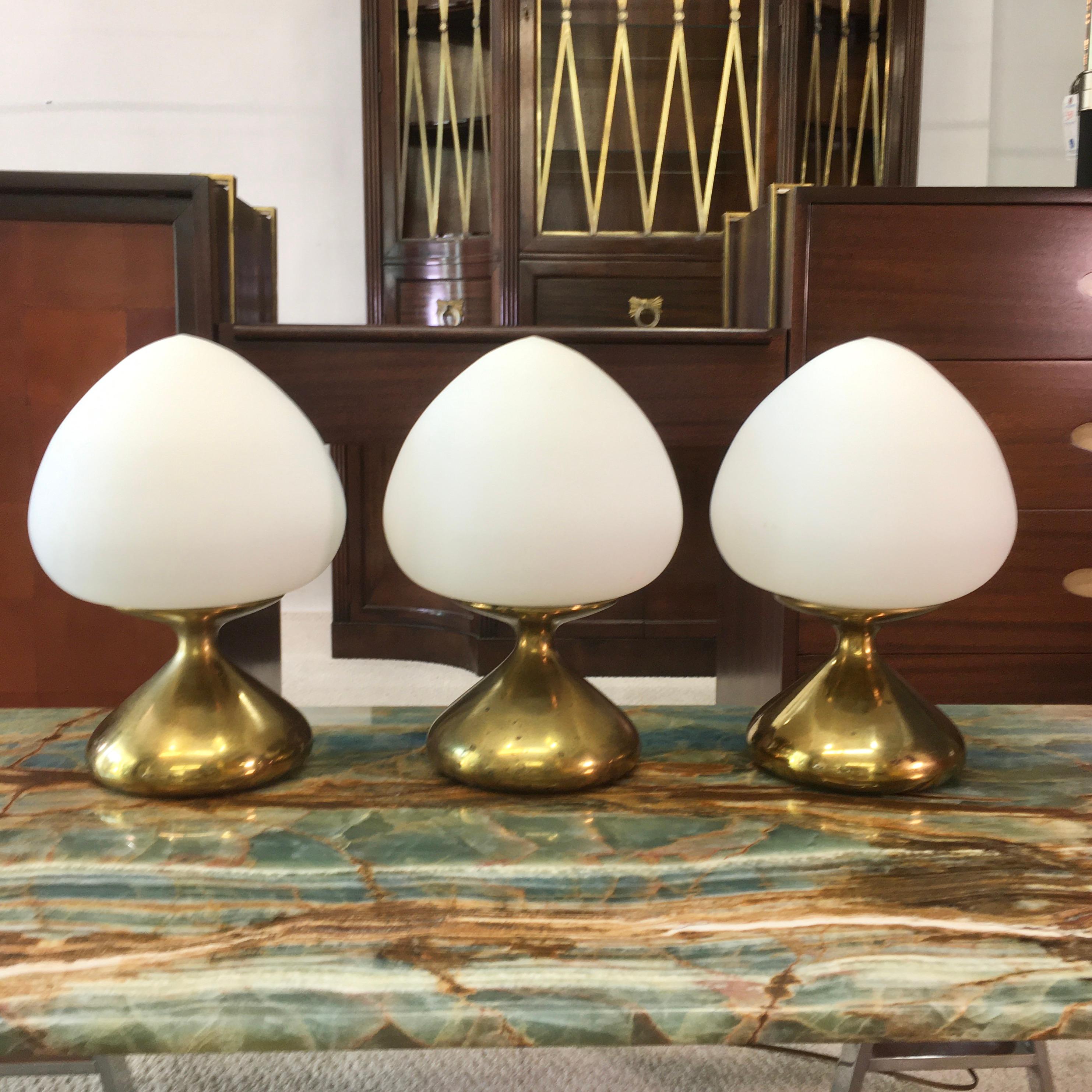 Three exceedingly rare table lamps designed by Tony Paul for Westwood Industries, circa 1965. Brass finished cast metal base with original satin opaline glass mushroom/acorn shaped globes. See original vintage Tony Paul/Westwood catalog page for