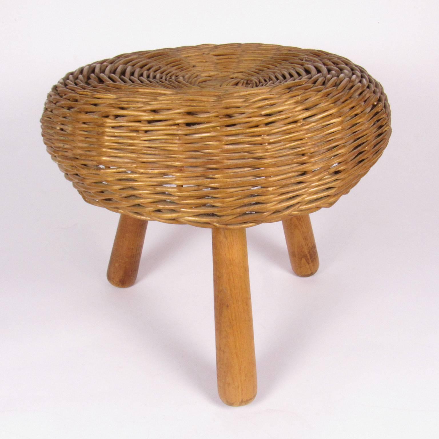 Tony Paul Mid-Century Modern wicker tripod stool, circa 1950/ round wicker top supported by tripod legs. Measures: Height 12 inches, diameter 12 1/2 inches.
